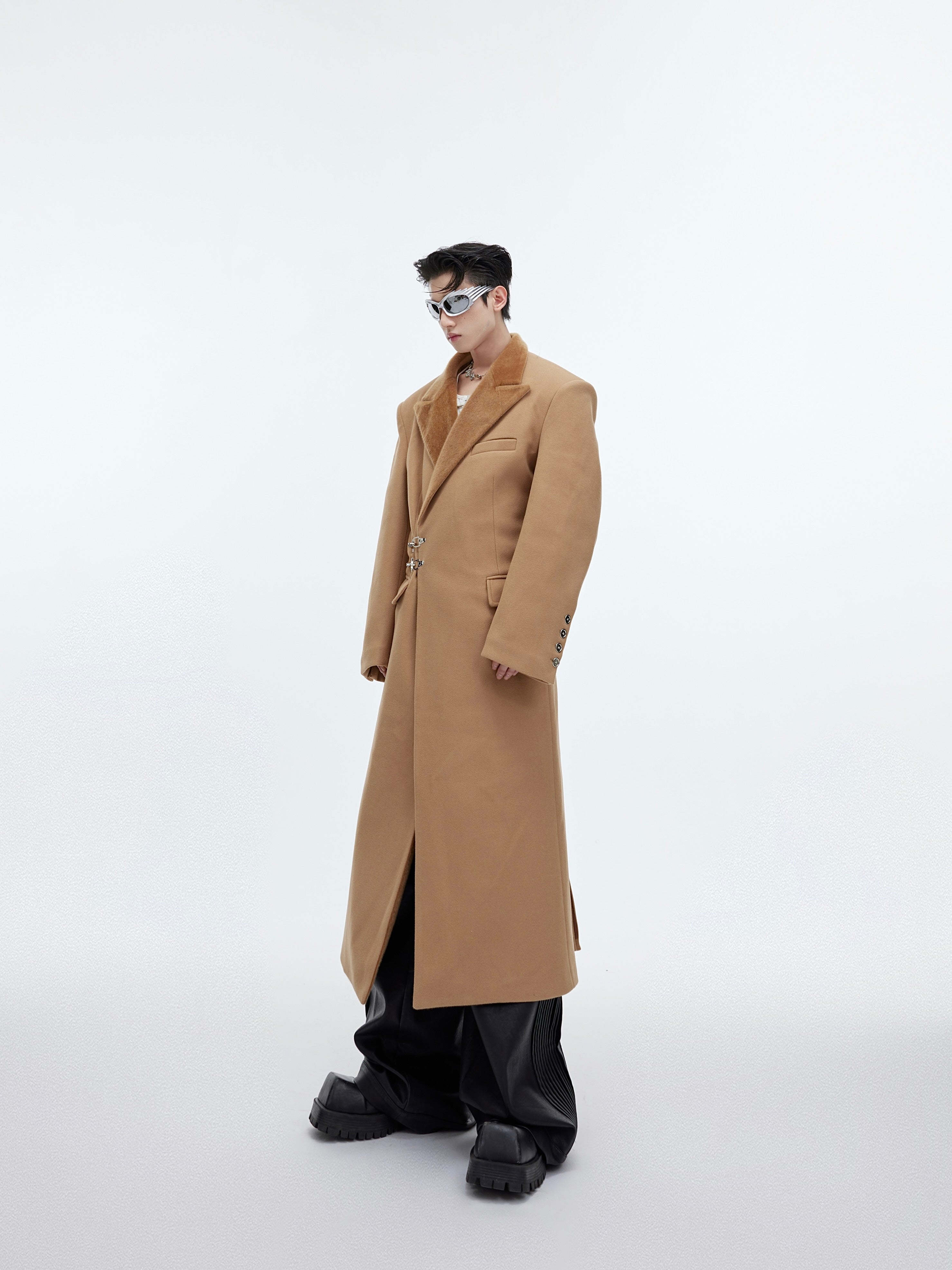 Rear view of deconstructed trench coat highlighting the custom metal airplane buckle closures