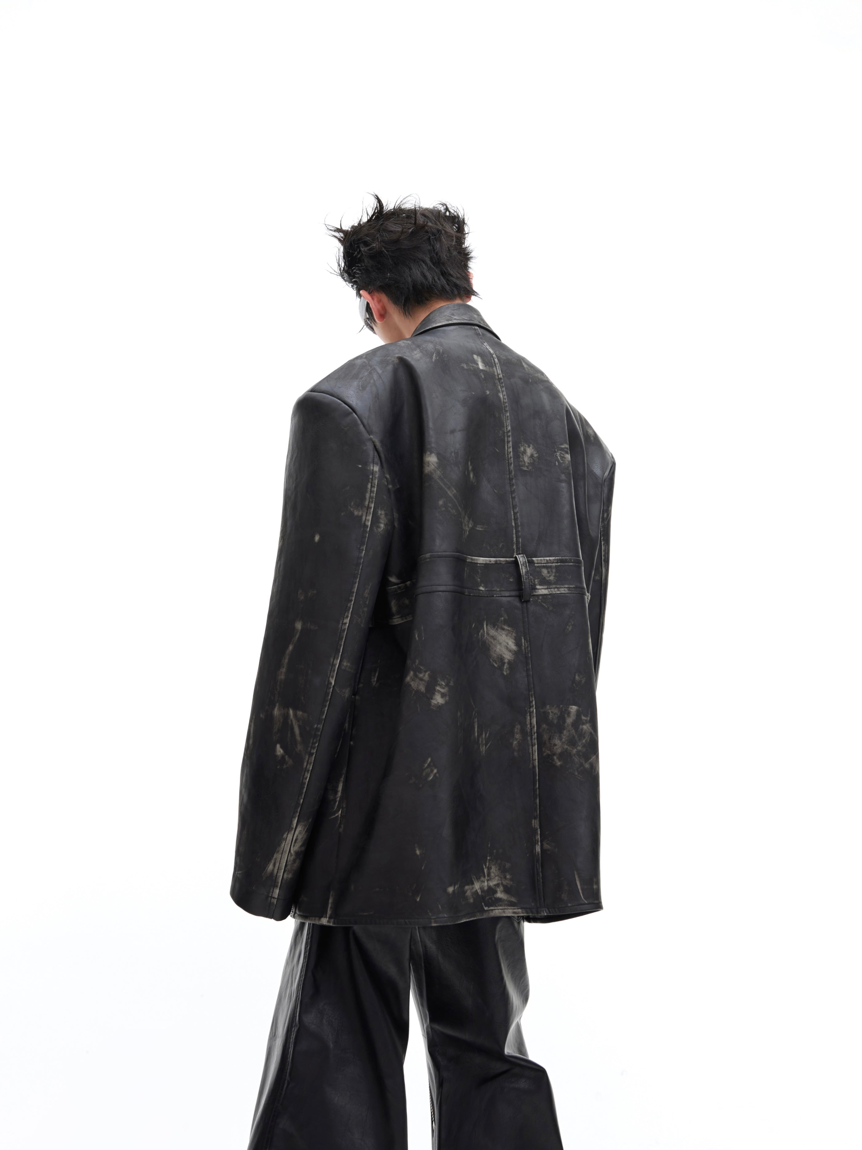 Front view of distressed vintage PU leather blazer with oversized shoulders and deconstructed detailing