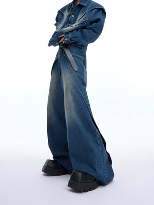 Close-up back view of cropped denim jacket showing raw edge deconstructed design elements