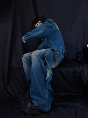 Detail shot of wide leg denim pants showing unique pocket stitching and distressed finish