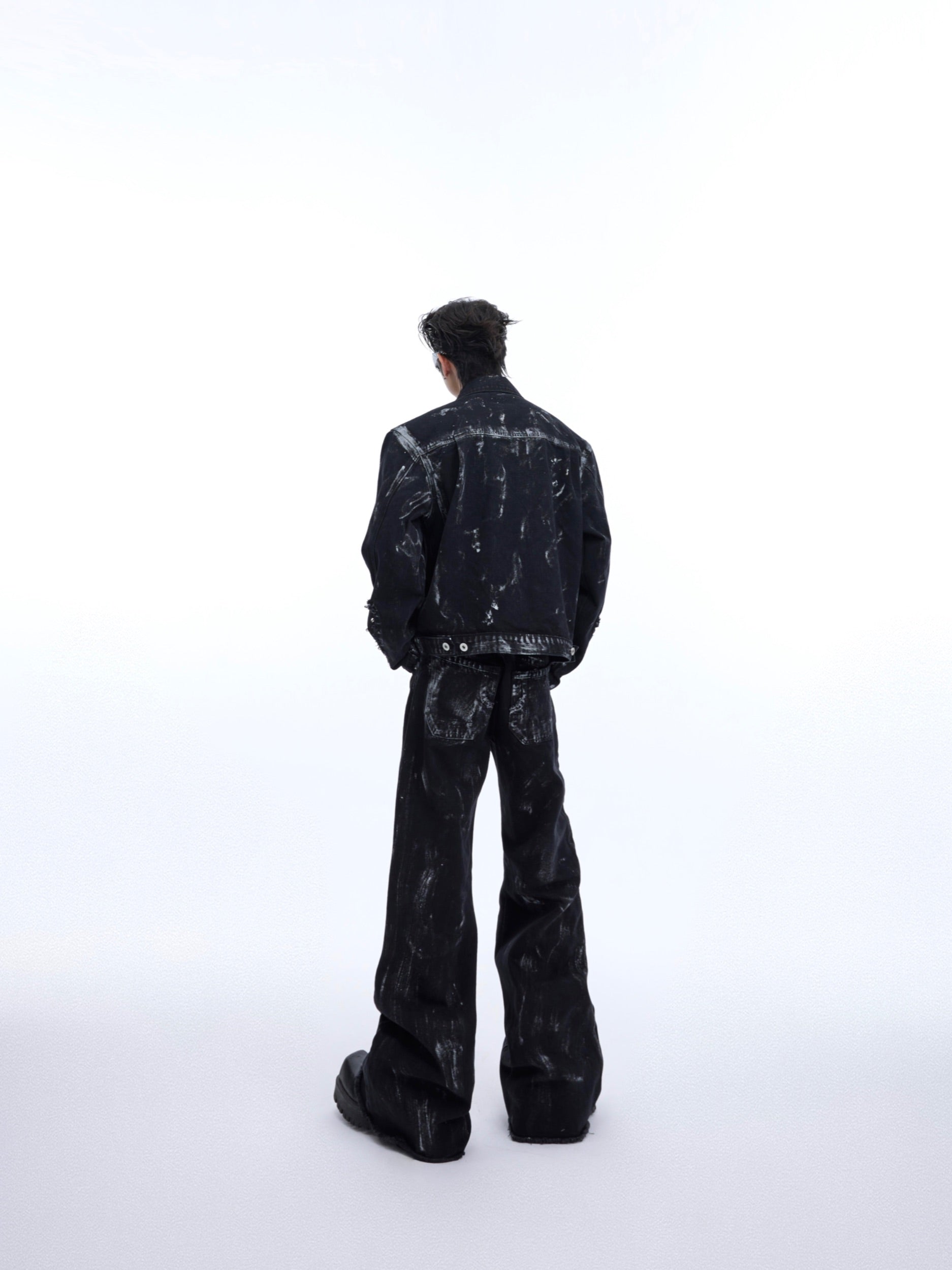 Front view of distressed denim jacket and jeans set showing raw hems and unique deconstructed design