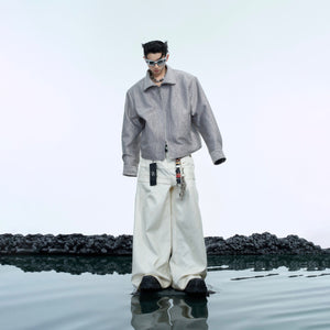 Close-up of detachable cape feature on deconstructed vest jacket for versatile streetwear styling