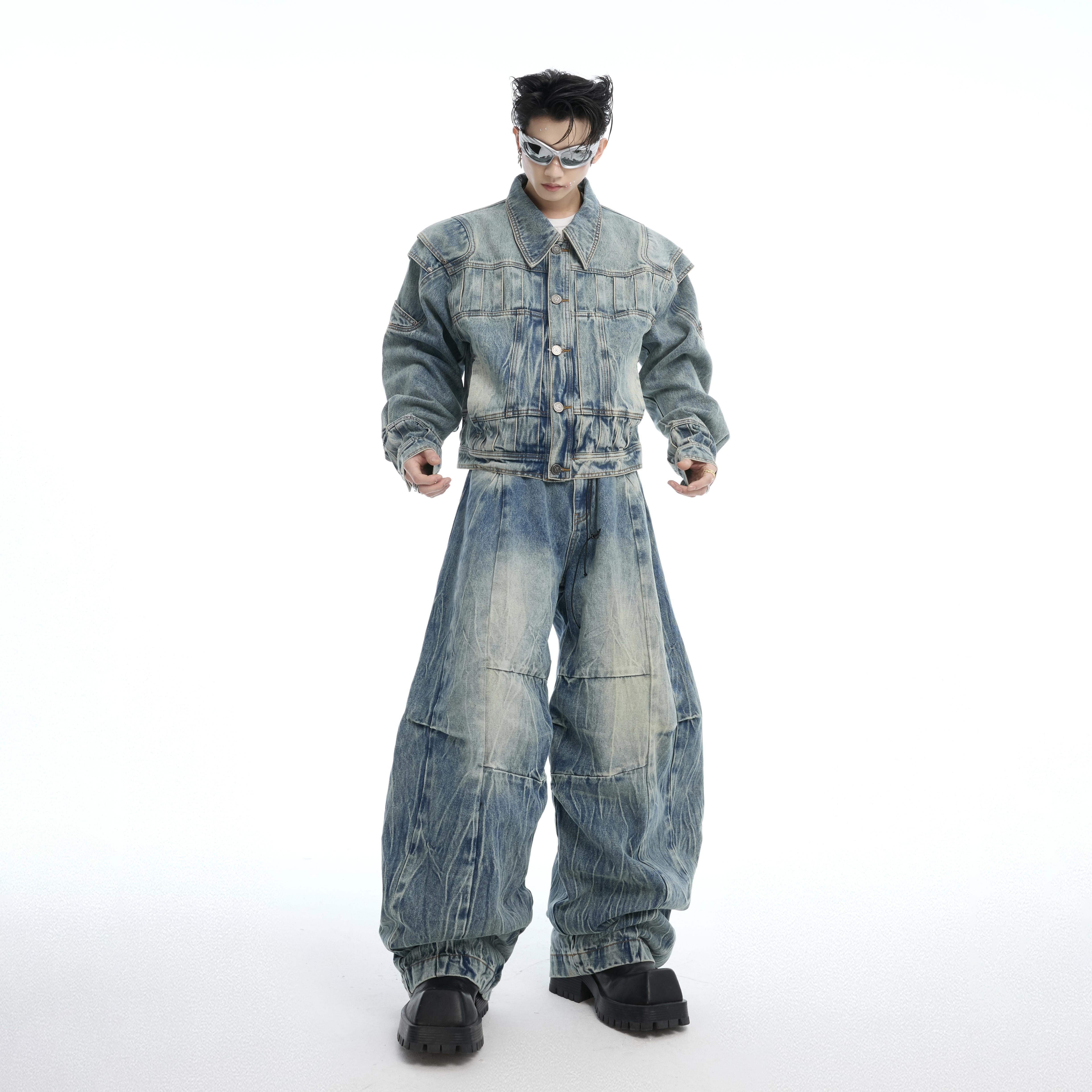 Distressed baggy jeans with armor-inspired silhouette, showcasing 3D pleating and deconstructed streetwear details
