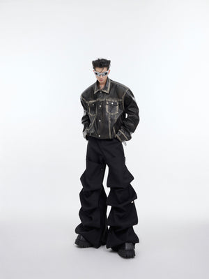 Fashion model wearing oversized distressed leather biker jacket with cropped streetwear style