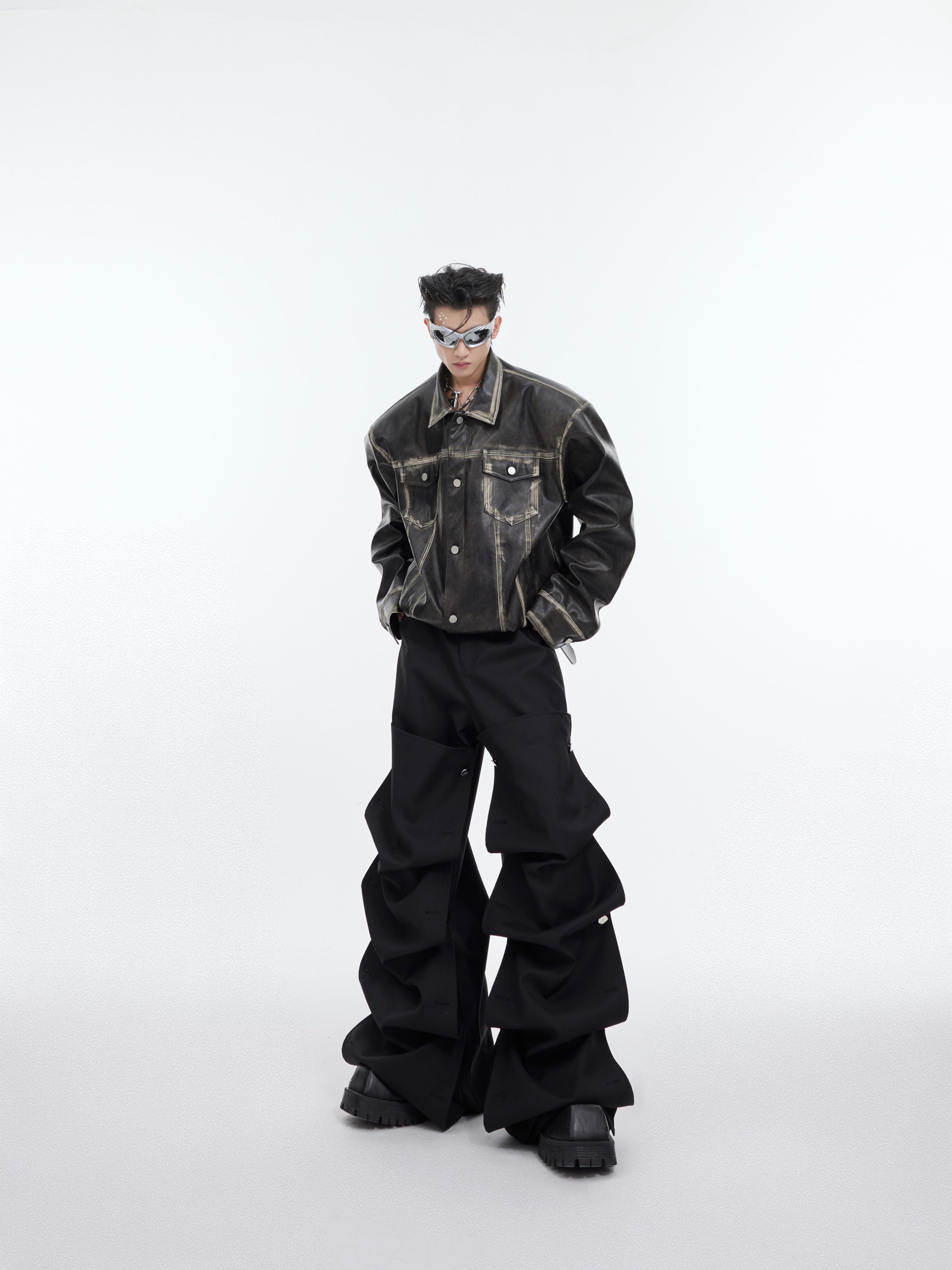 Fashion model wearing oversized distressed leather biker jacket with cropped streetwear style