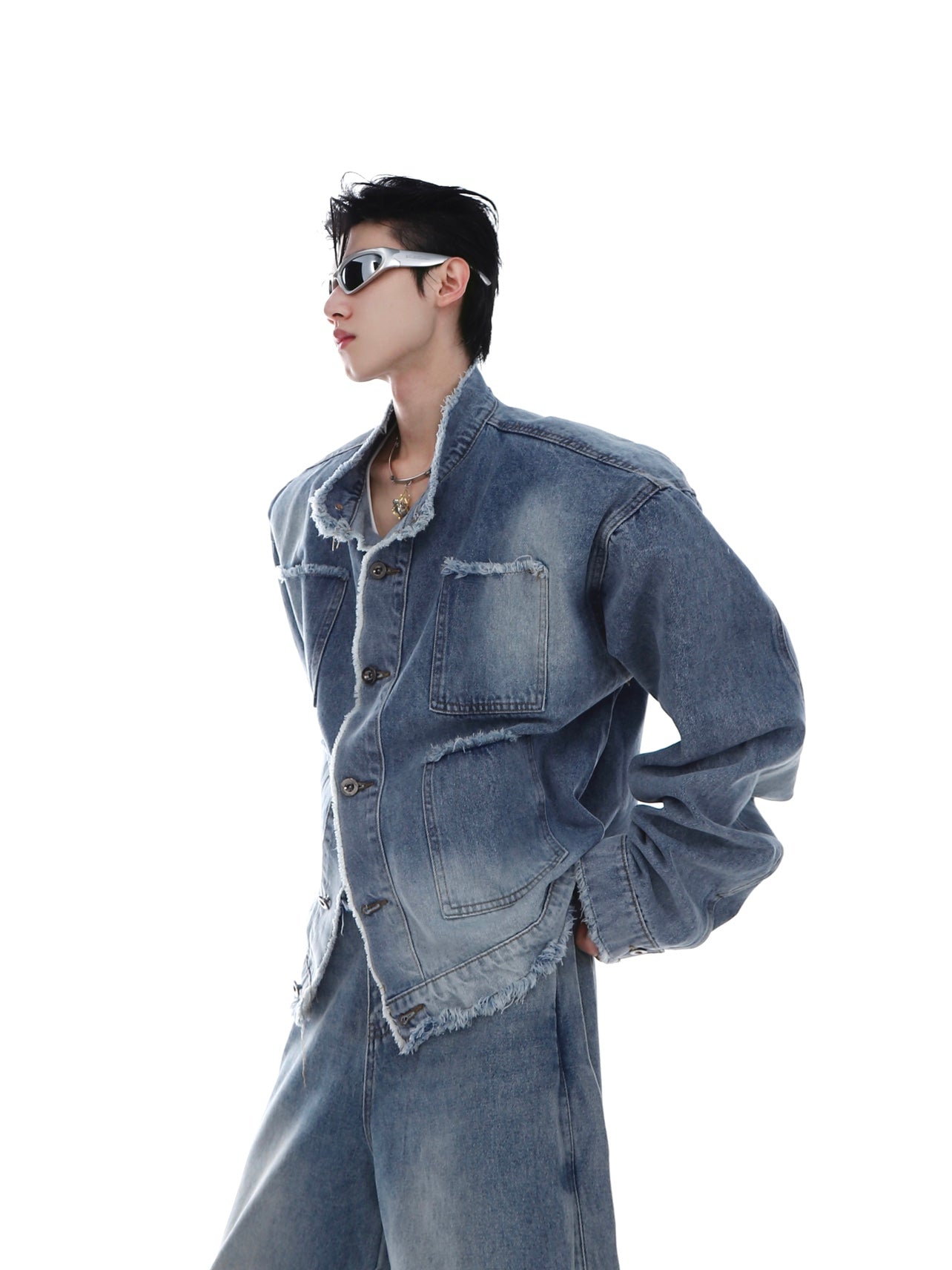 Distressed denim jacket featuring bold architectural lines and avant-garde tailoring for edgy street style