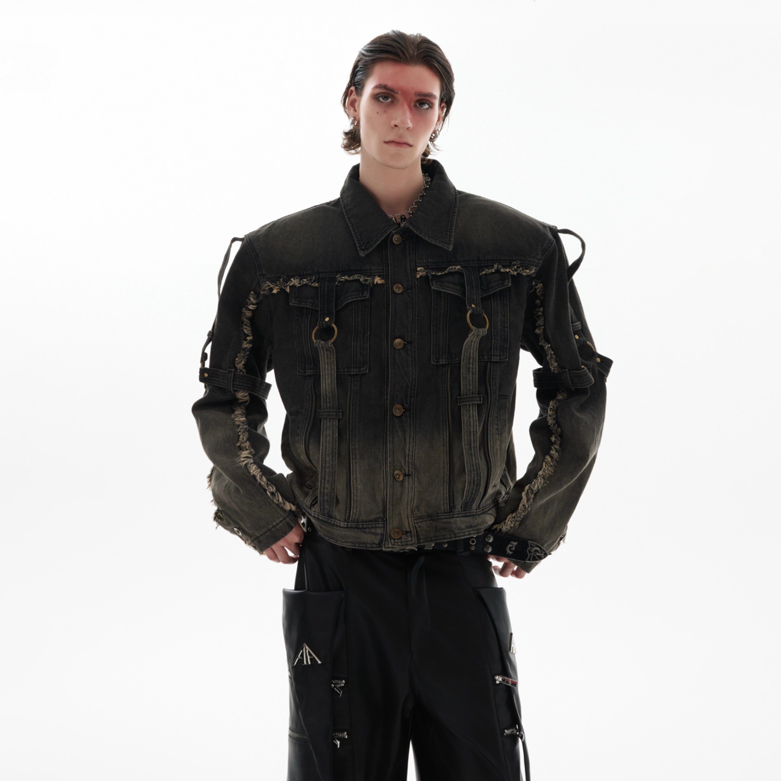 Front view of distressed denim jacket showcasing unique frayed hem details and deconstructed straps