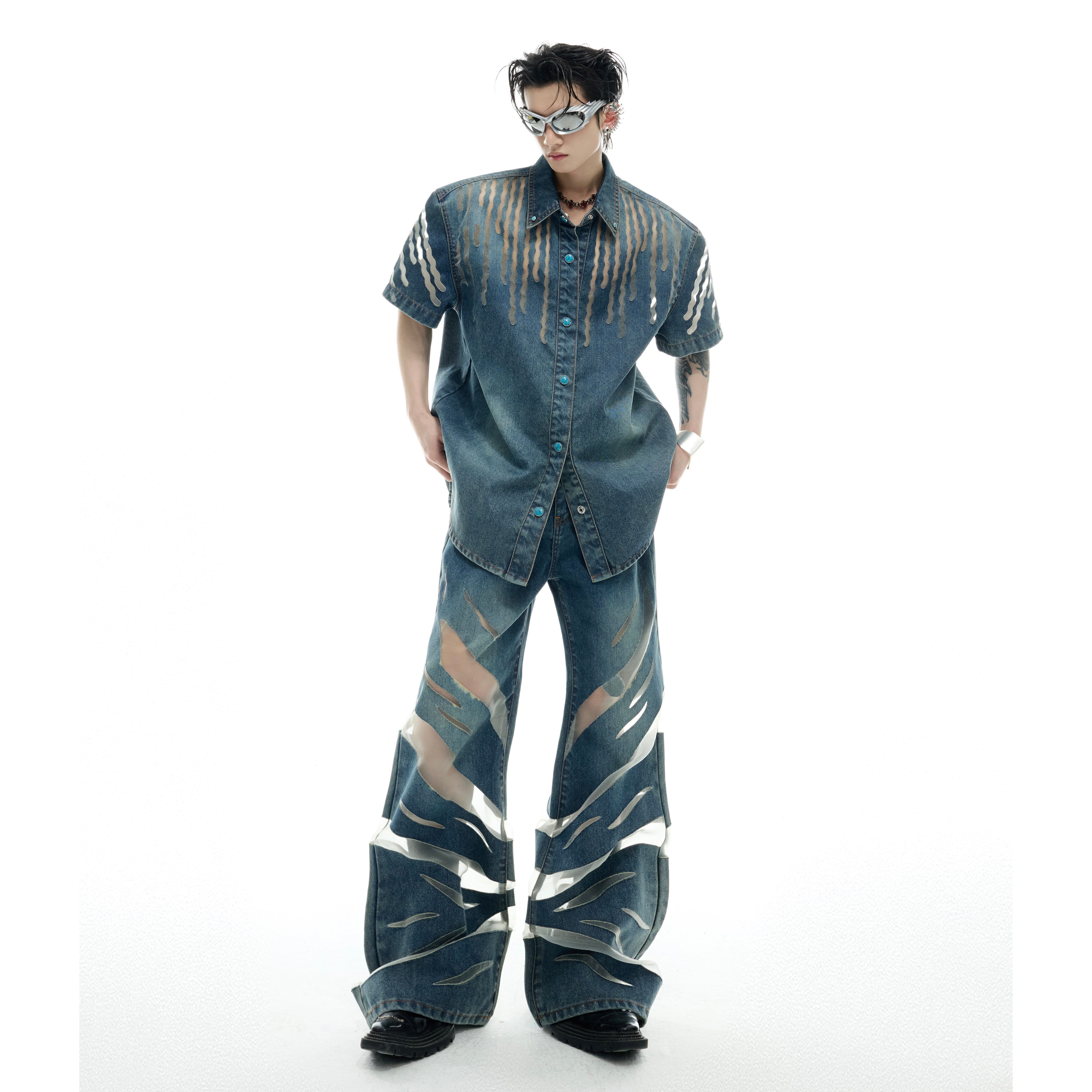 Front view of distressed denim jacket with cutout design and mesh panels for urban streetwear style