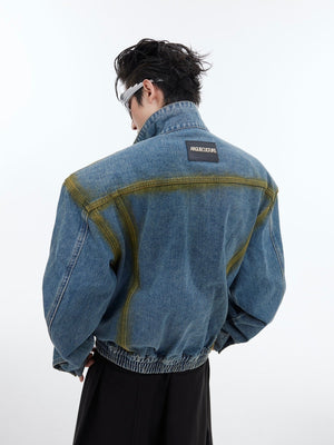 Detailed view showing sleeve construction and artistic dye patterns on this short denim coat