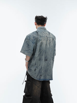 Close-up of the premium distressed denim fabric and hand-painted artistic details on this streetwear top