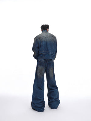 Close-up of back detailing on distressed denim jacket showing unique distressing patterns and stitching