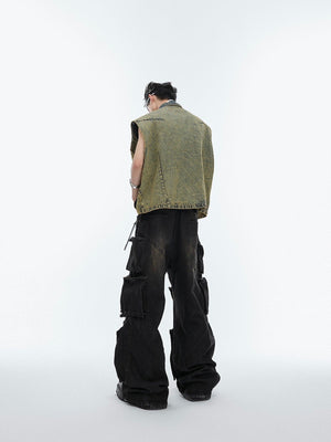 Back view of industrial-chic denim vest featuring bold rivet accents and distressed finish