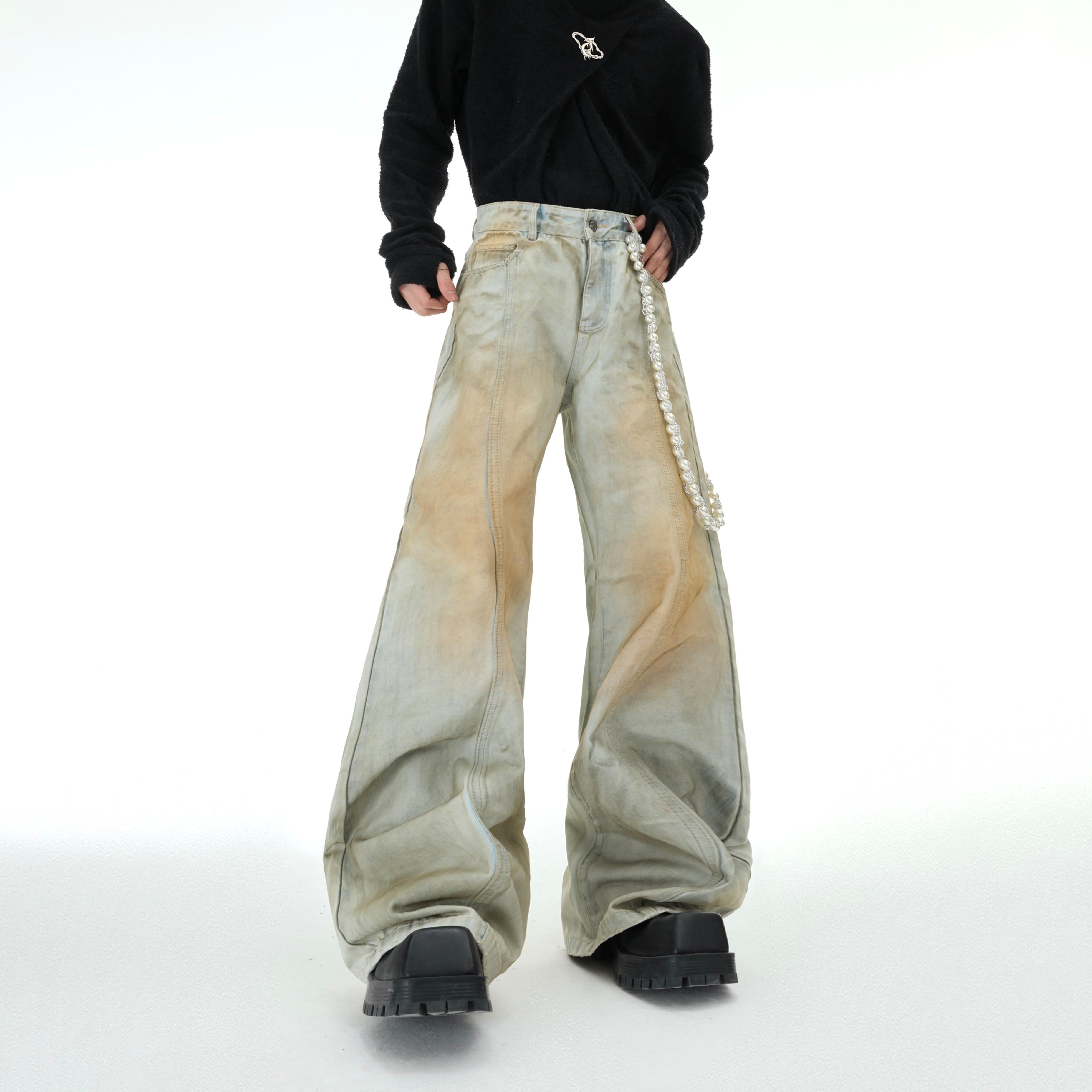 Vintage distressed flared jeans with detachable pearl chain trim, showcasing retro streetwear style
