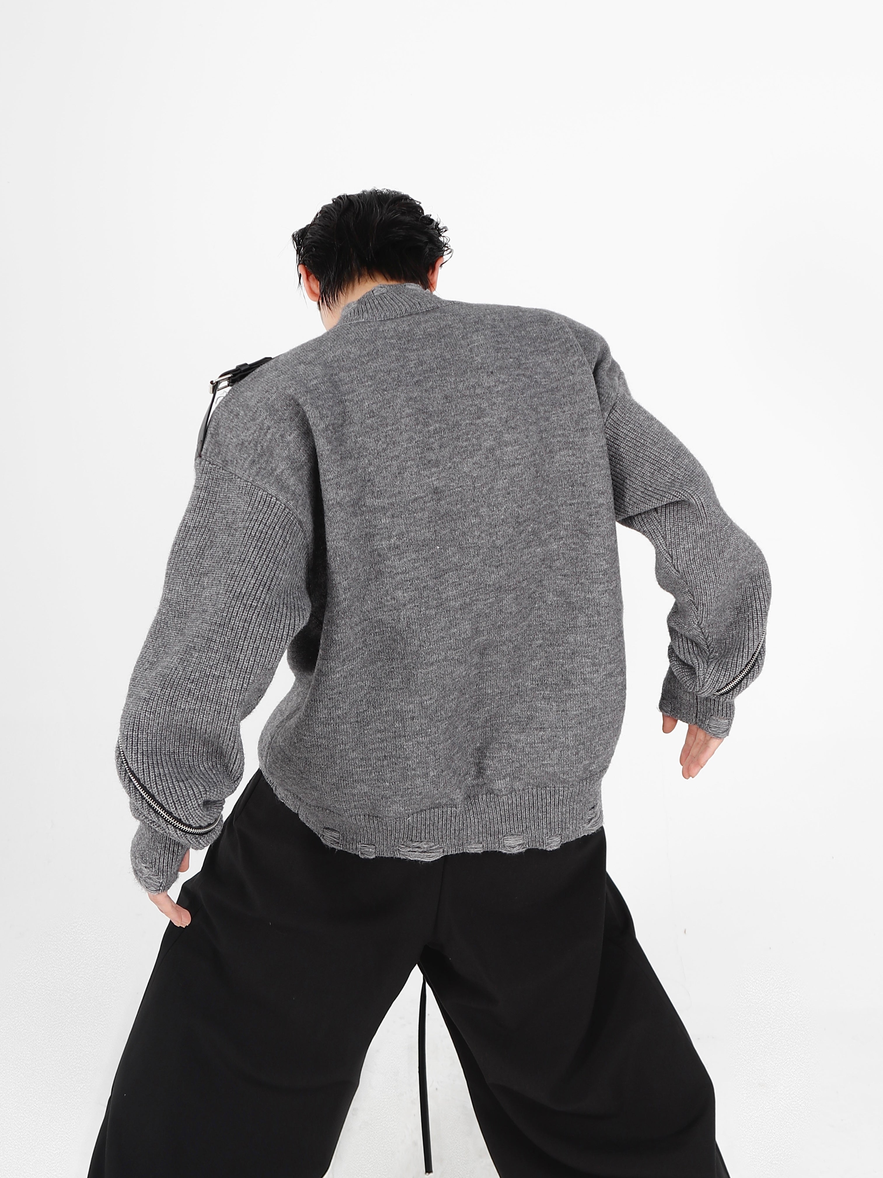 Stylish distressed knit cardigan shown as a layering piece with the zipper partially open for casual wear