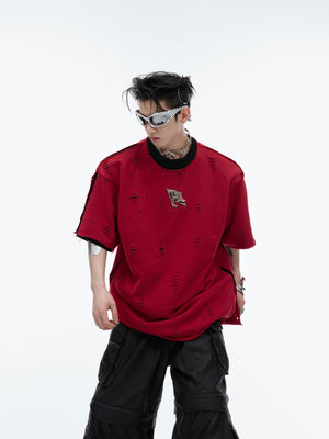 Distressed oversized t-shirt with unique faux two-layer design and metal accent details, avant-garde streetwear style