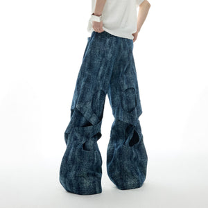 Distressed straight-leg jeans with pearl and rhinestone accents, featuring textured patchwork denim for edgy street style
