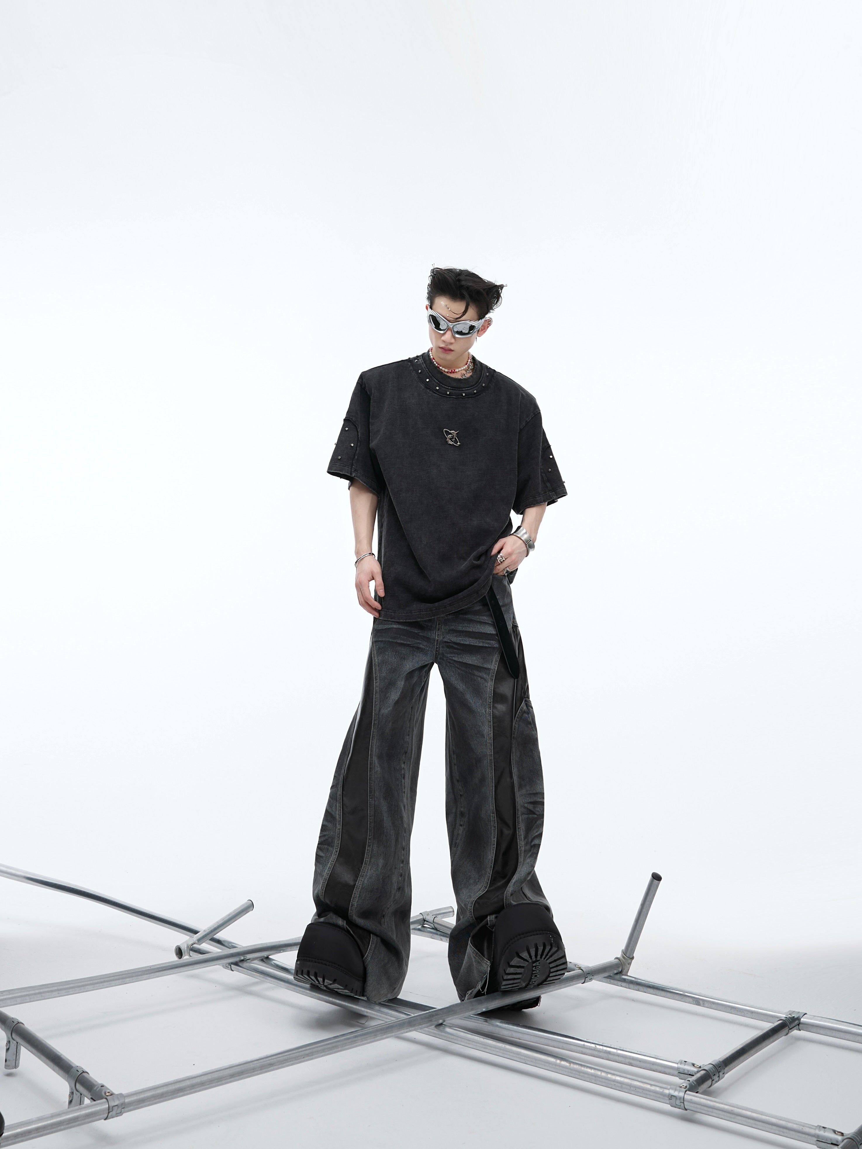 Side angle of model wearing the oversized vintage tee highlighting the deconstructed edges and stud details