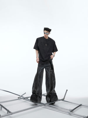 Side angle of model wearing the oversized vintage tee highlighting the deconstructed edges and stud details
