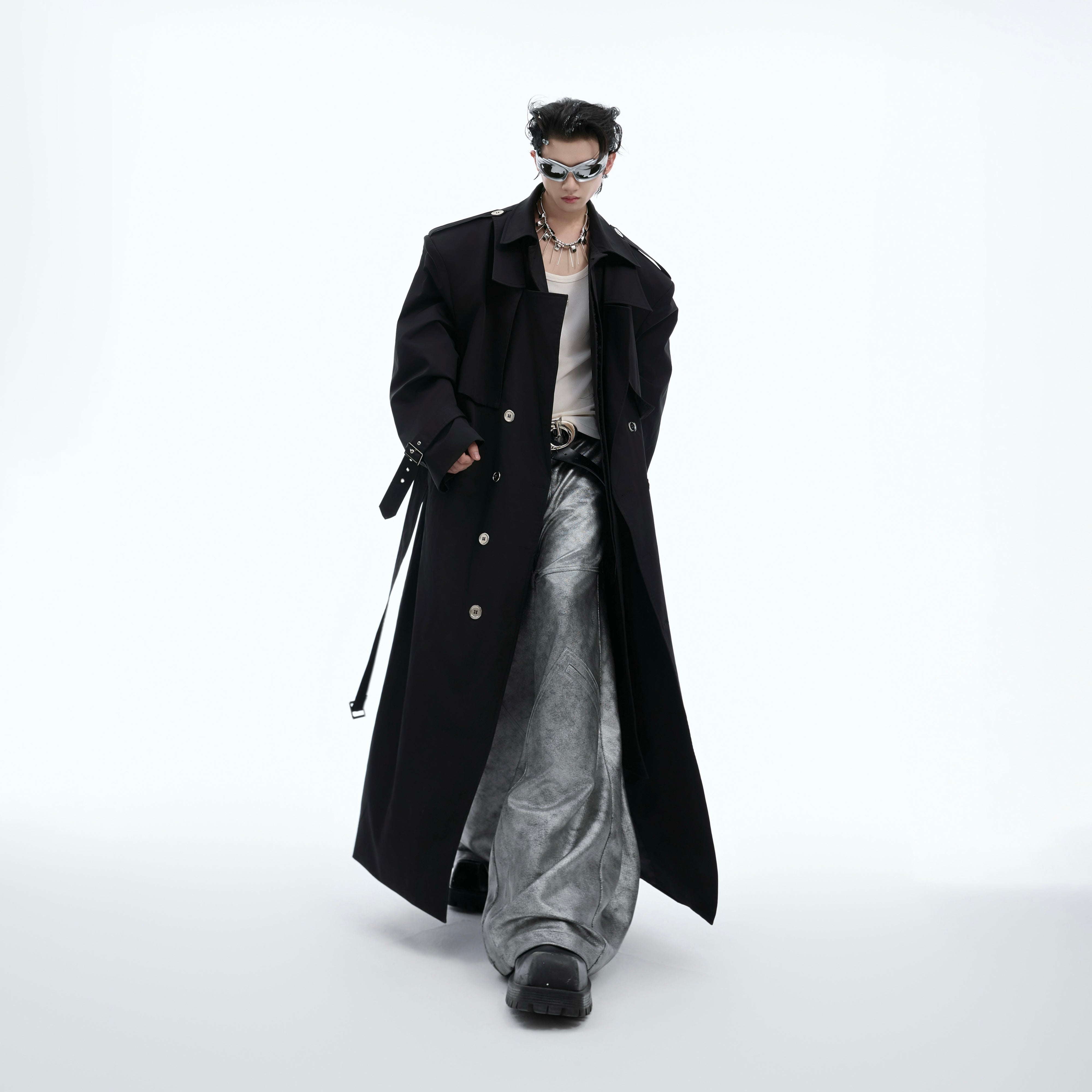 Back view of the double-breasted trench coat highlighting its deconstructed design and sophisticated silhouette