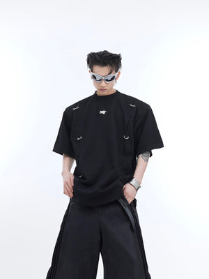 Close-up of avant-garde metal detailing on deconstructed drop-shoulder streetwear t-shirt
