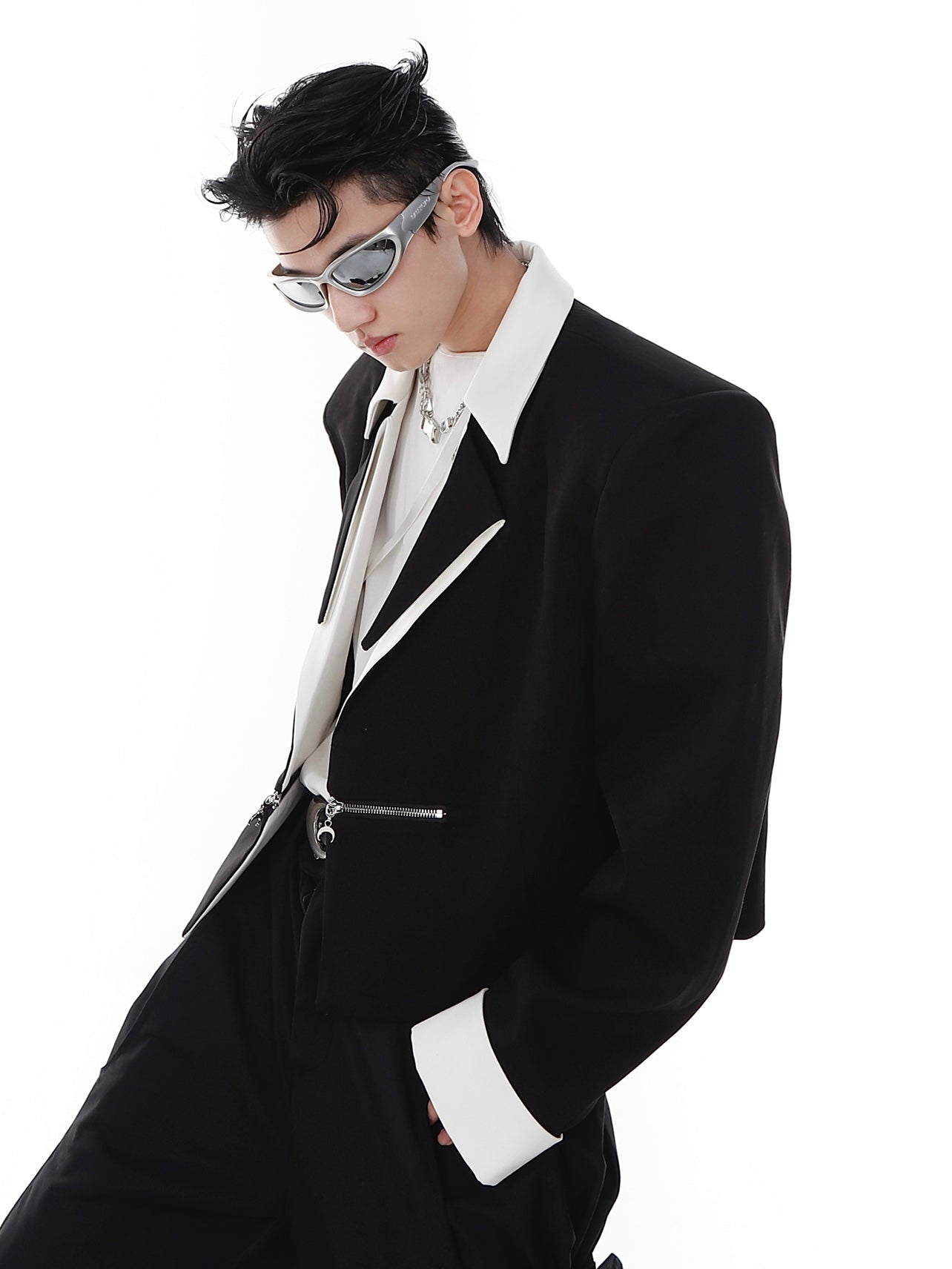 Model wearing the avant-garde black and white deconstructed blazer showing its oversized fit and urban aesthetic