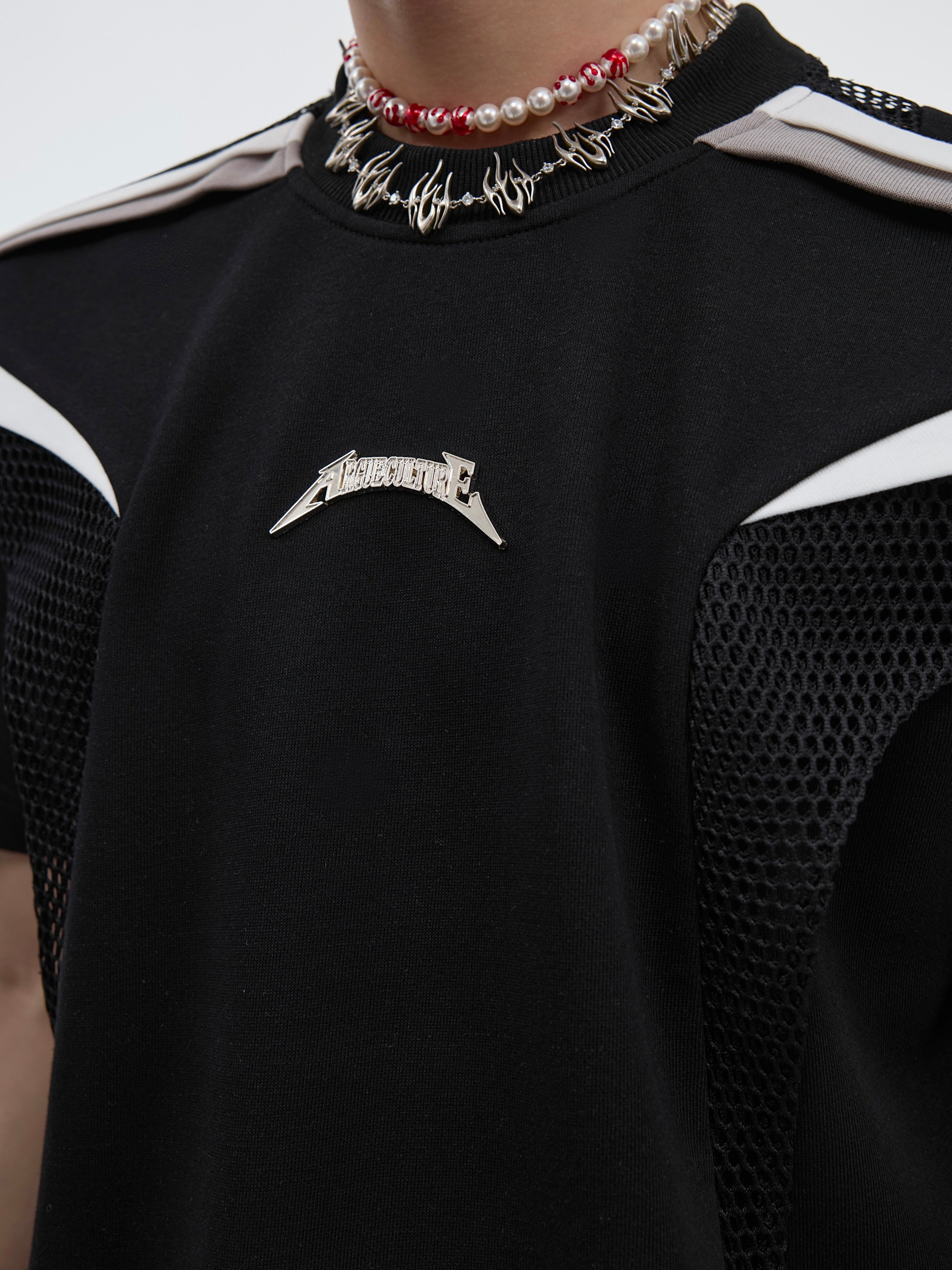 Fashion-forward streetwear top with accentuated silhouette and modern deconstructed design