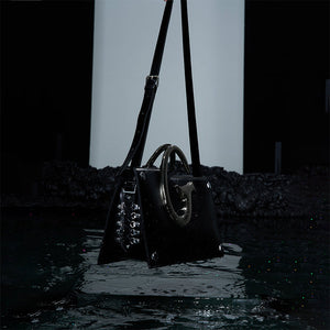 Trendsetting shoulder bag with asymmetrical shape and premium metal chain handle details