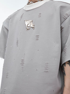 Side angle showing the faux two-layer construction and distressed hem details of this unique oversized tee