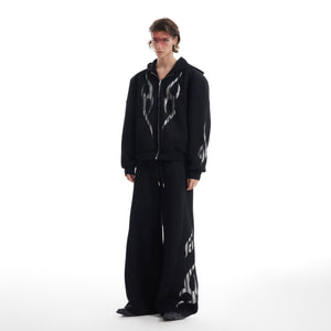 Side angle of deconstructed flame hoodie showing extended sleeves and oversized streetwear silhouette