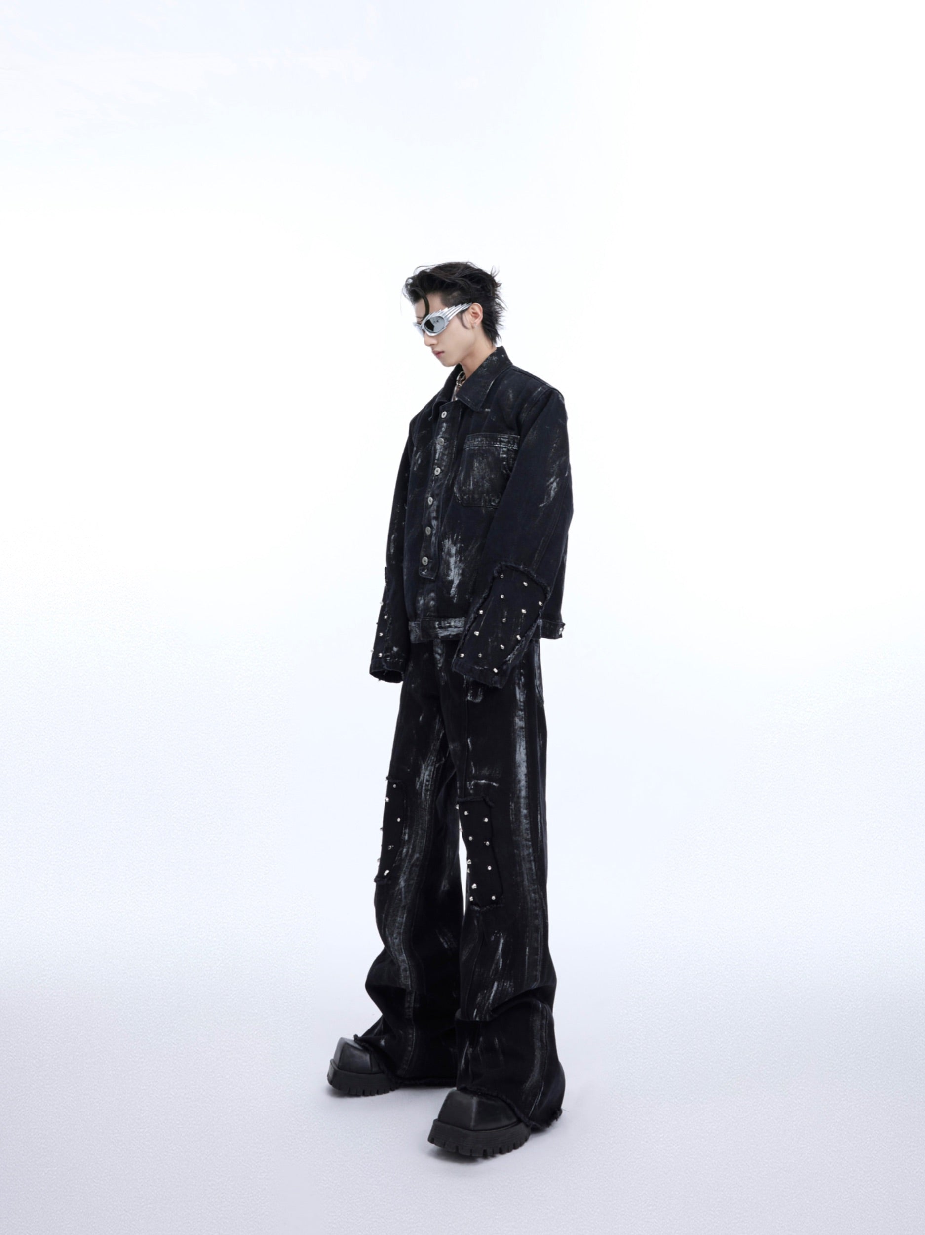 Vintage-style flared jeans with artistic airbrush detailing, part of deconstructed denim set for edgy streetwear