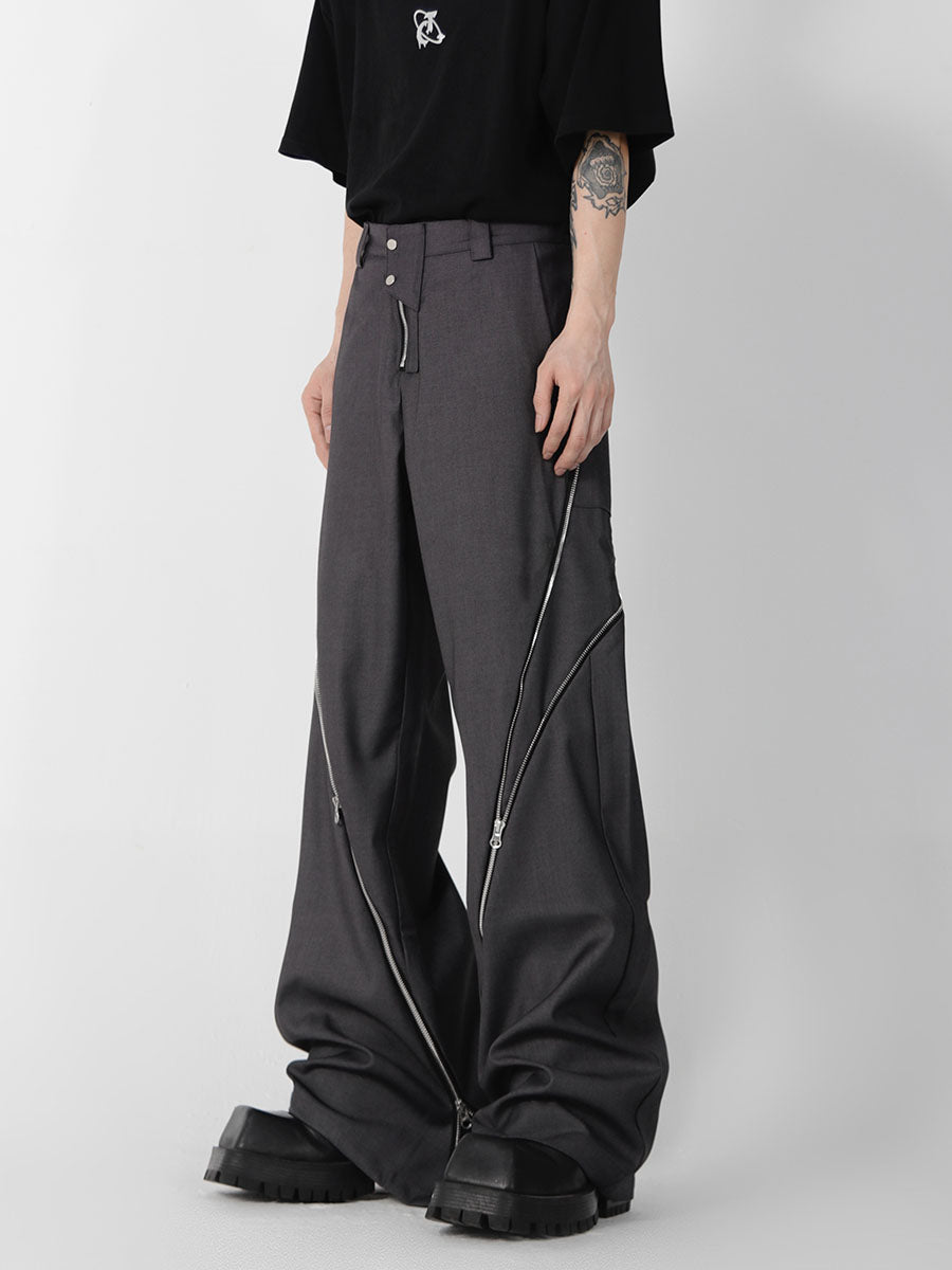 Close-up of distressed straight-leg trousers featuring unique front zipper design and contemporary tailoring
