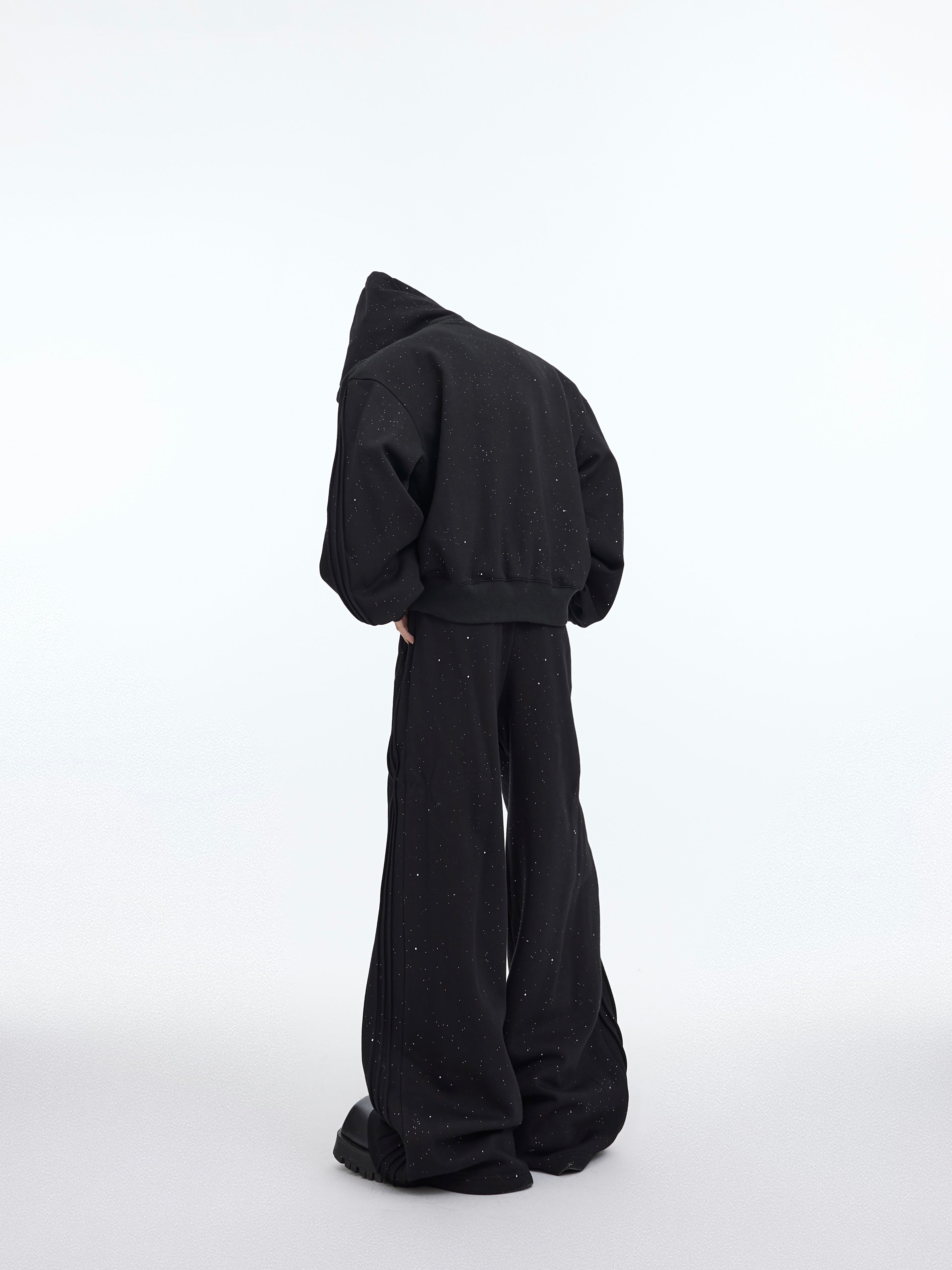 Model wearing complete oversized hoodie and distressed pants set showing urban streetwear style