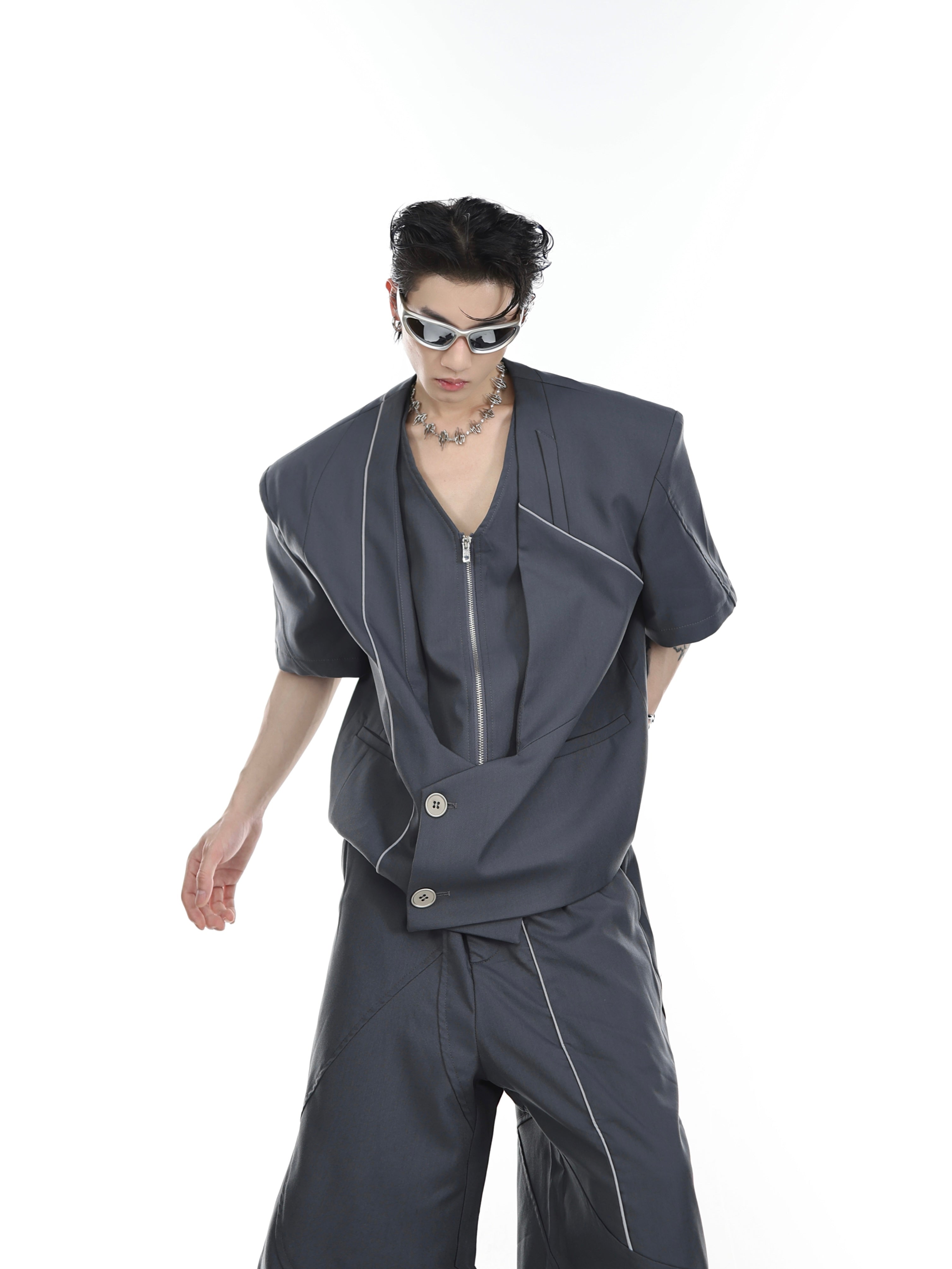 Side angle showing the modern two-piece blazer set with reflective trim detailing and architectural lines