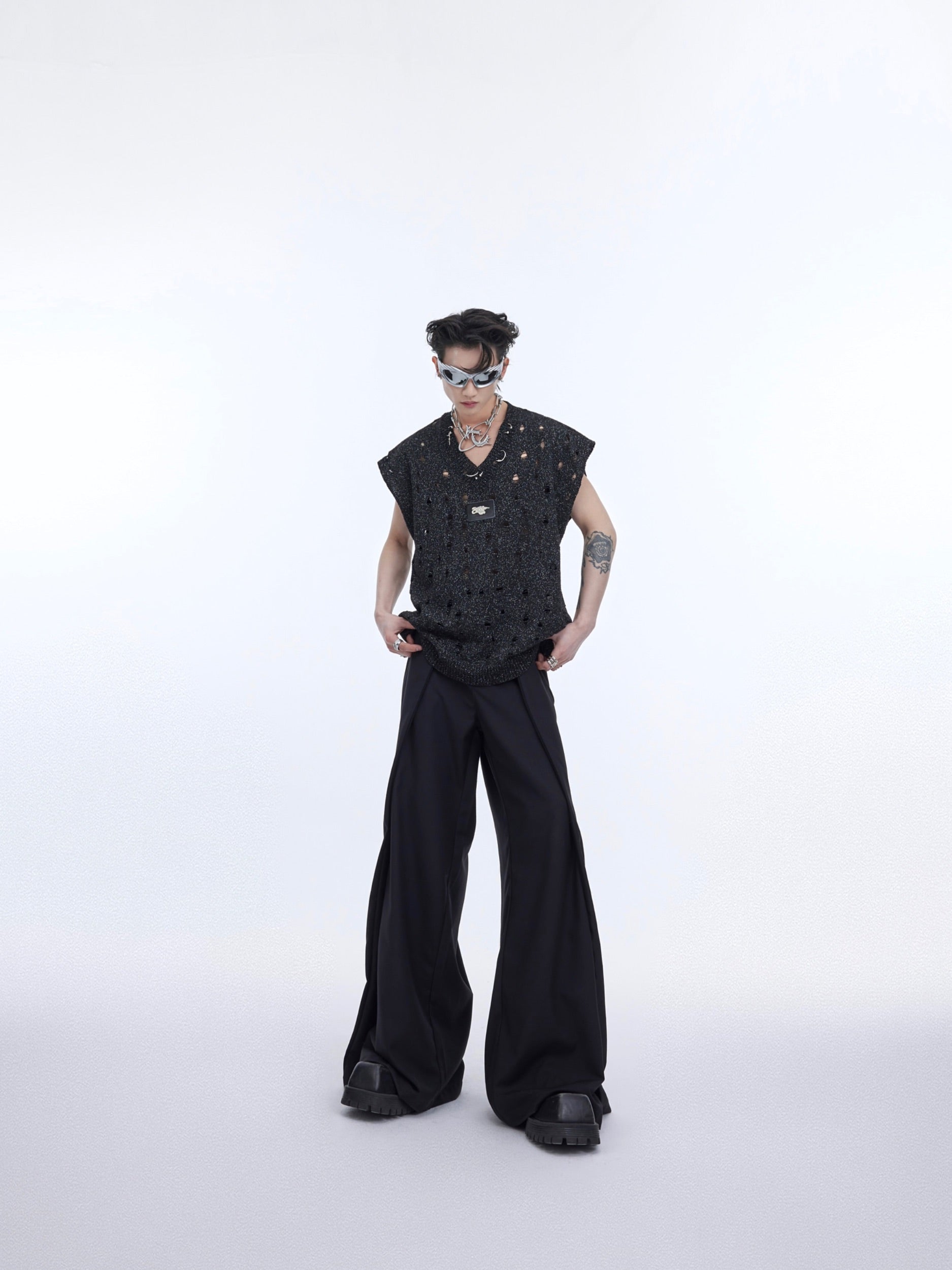 Back view showing the glossy sheer cape attached to this deconstructed metallic knit vest