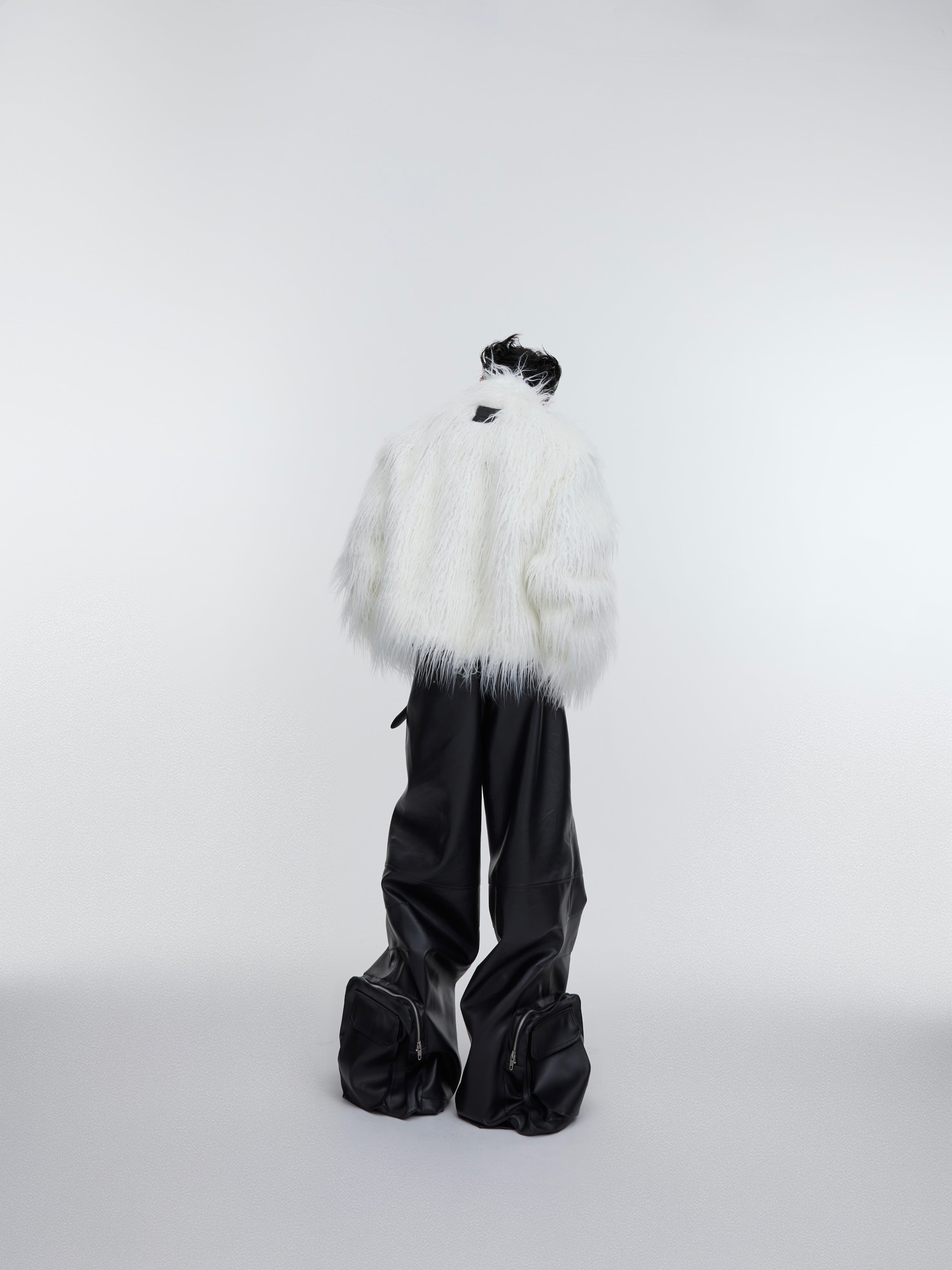 Close-up detail of the heavyweight faux fur coat showing the luxurious long pile texture and wave print pattern