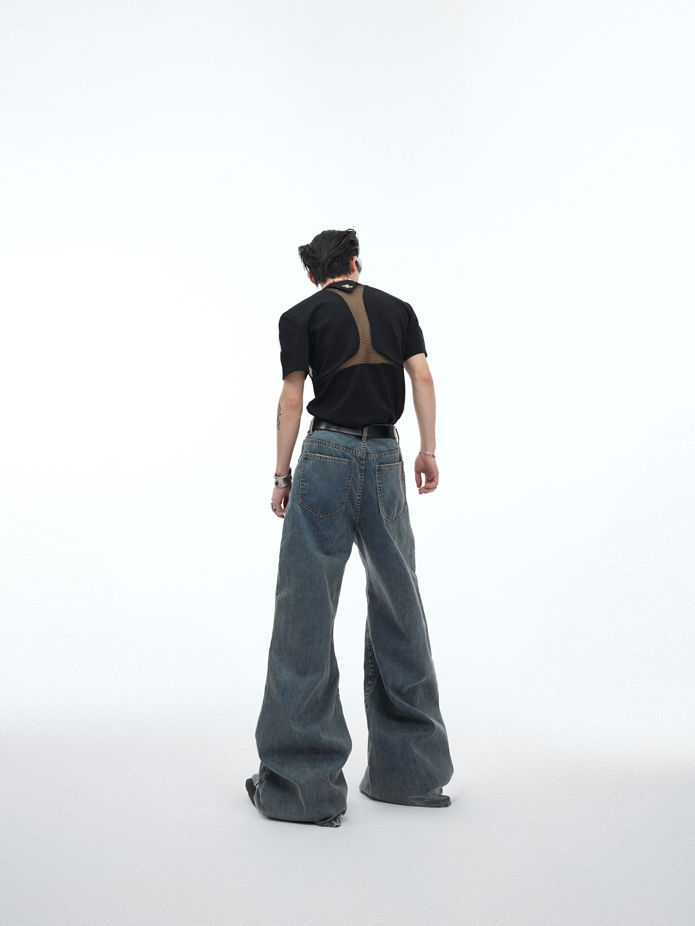 Close-up of the hollow-out detailing and distressed texture on these vintage-inspired streetwear flared jeans