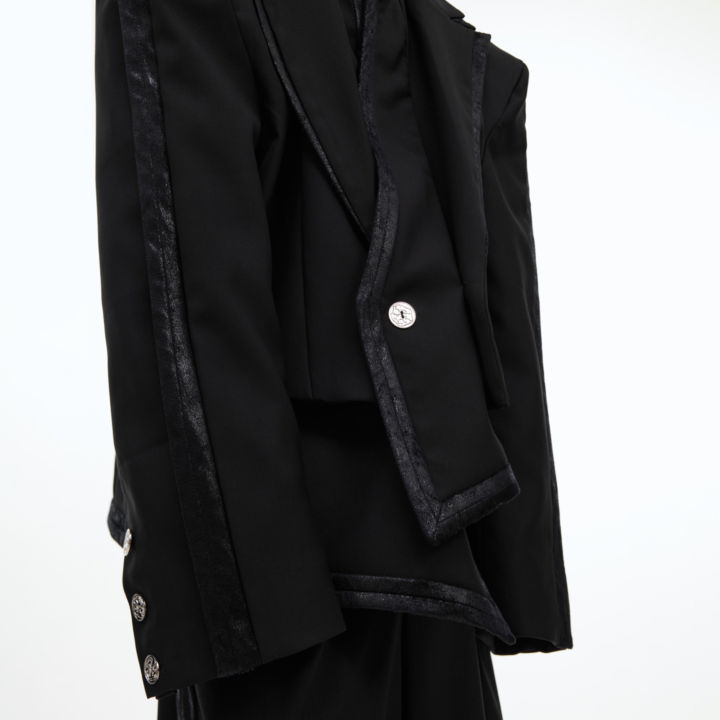 Back view of the deconstructed blazer showing unique double collar design and loose silhouette