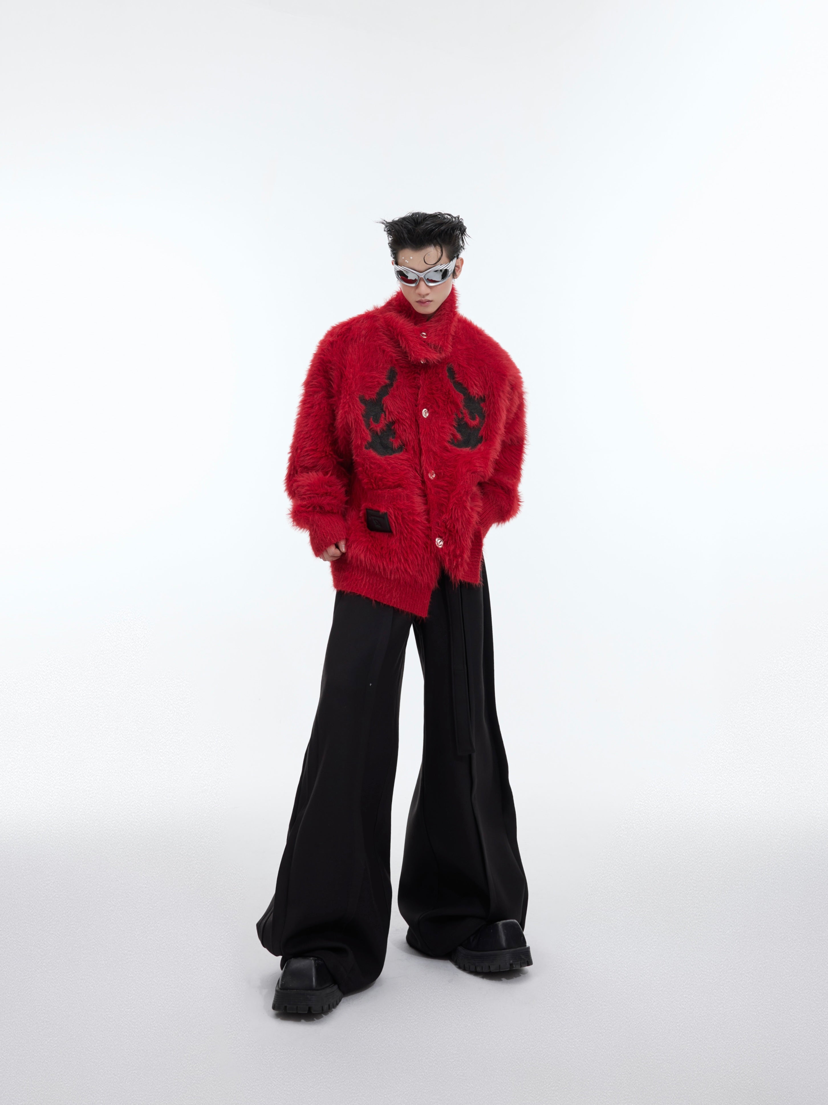 Front view of model wearing oversized red fleece cardigan with statement high neck collar