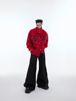 Front view of model wearing oversized red fleece cardigan with statement high neck collar