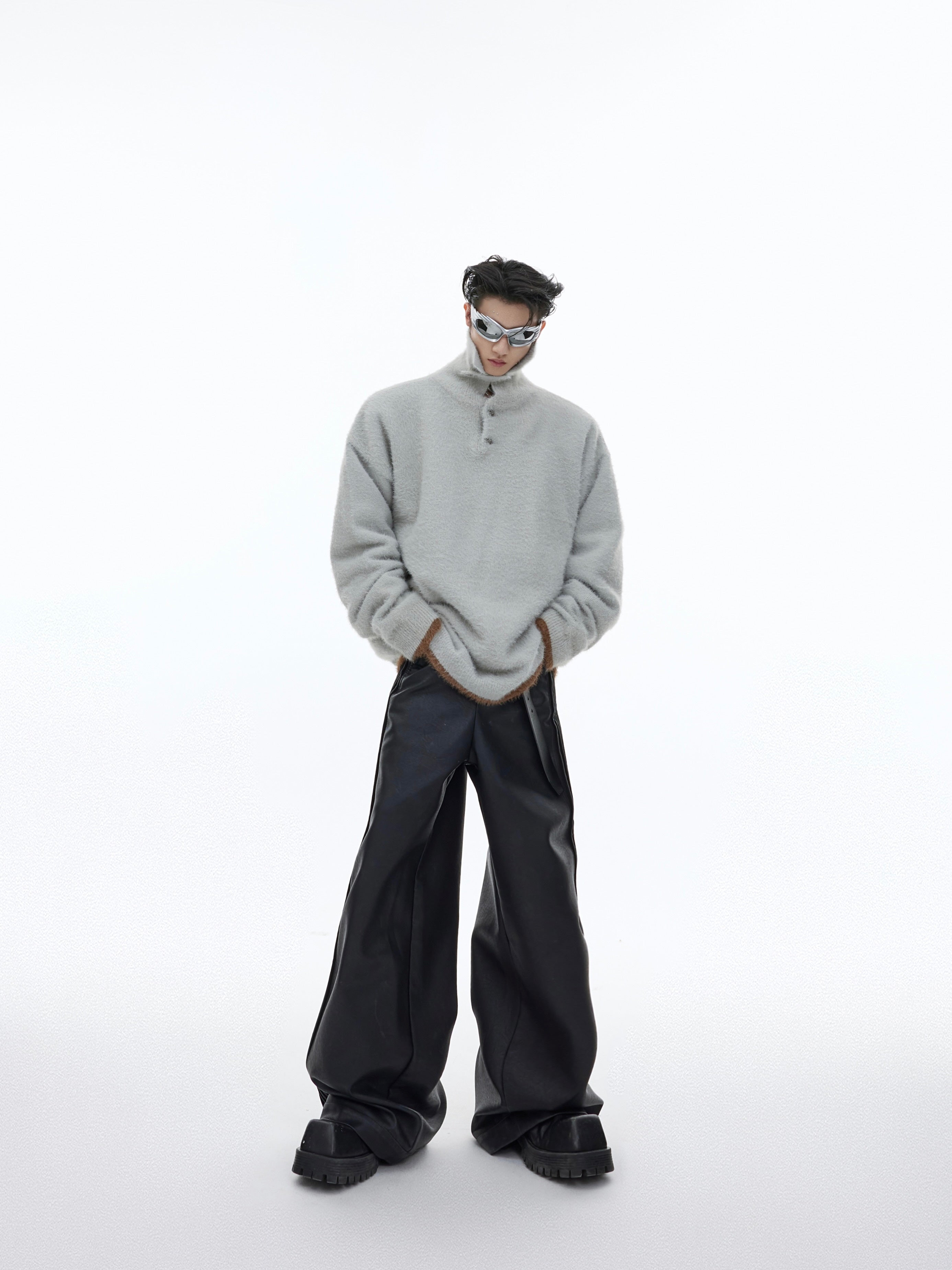 Streetwear model wearing the oversized color-blocked pullover with distressed jeans