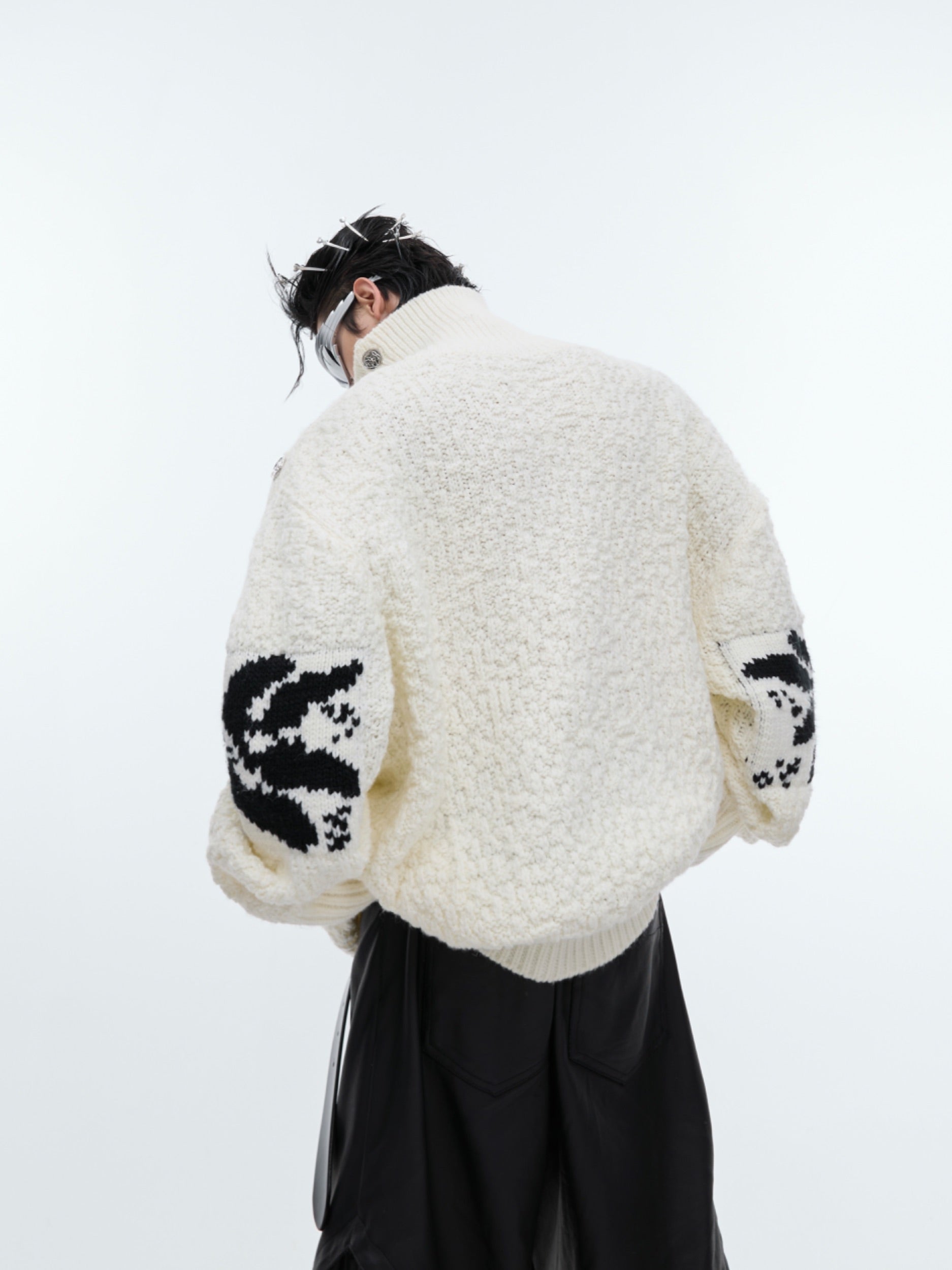 Detail shot showcasing the unique metal button closures on this retro-style oversized knit sweater