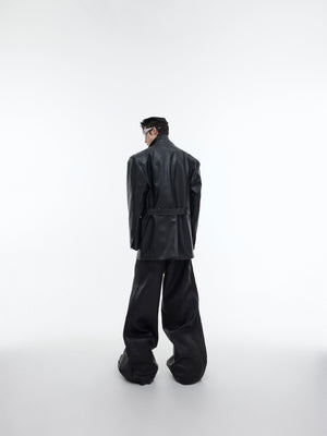 Styling example of oversized belted blazer layered over streetwear outfit for dark academia look
