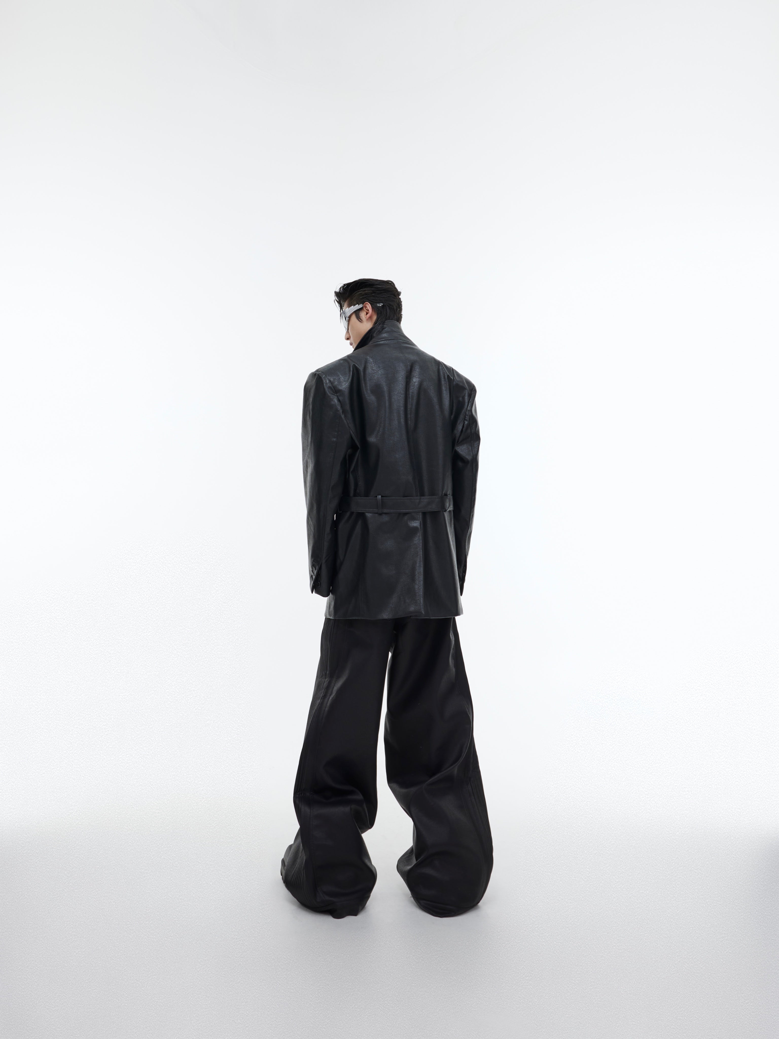 Styling example of oversized belted blazer layered over streetwear outfit for dark academia look