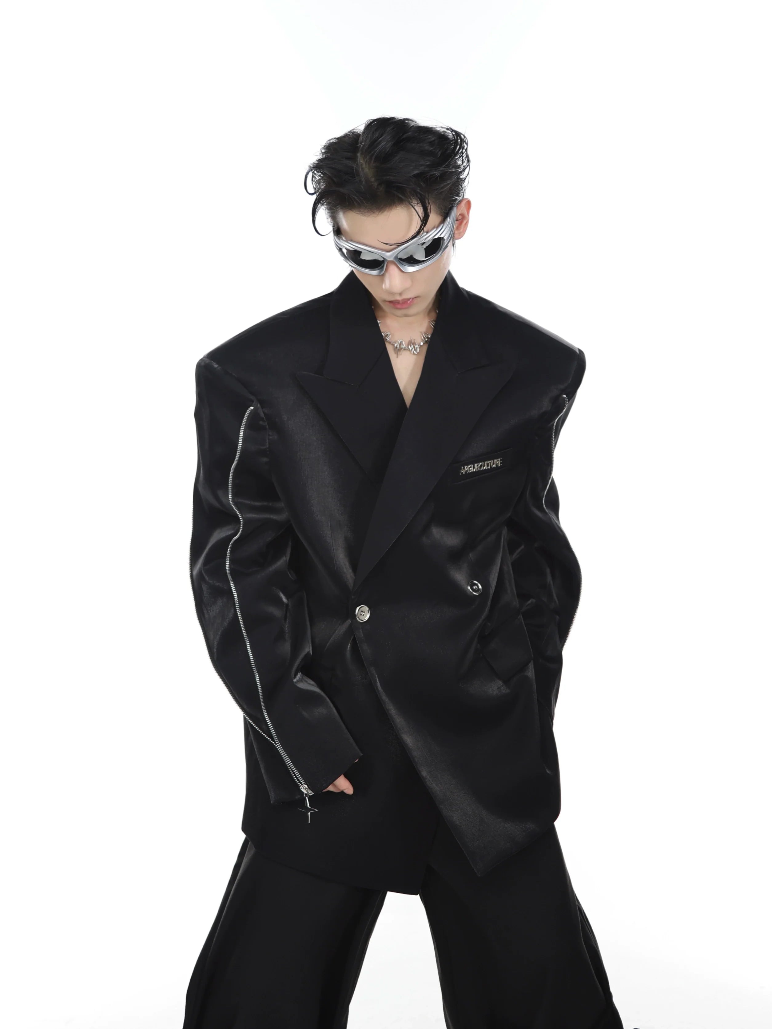 Front view of metallic blazer featuring striking shoulder pads and liquid metal fabric that catches the light beautifully.
