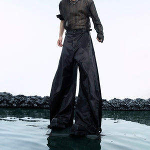 Front view of liquid metal wide-leg pants showcasing the unique scimitar cut silhouette for urban streetwear fashion