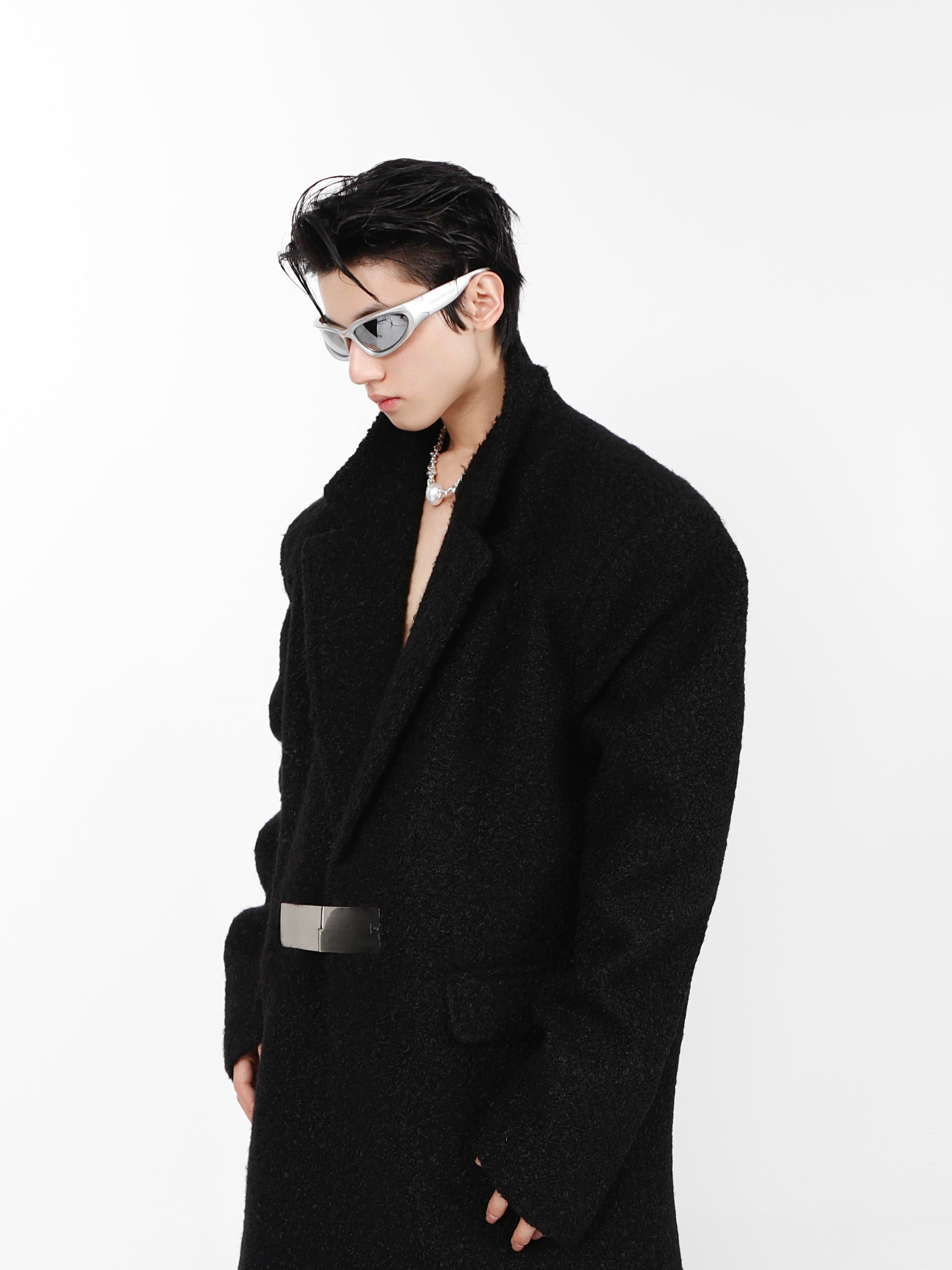 Side profile of avant-garde tech jacket showing lamb-fur padded shoulders and sleek silhouette