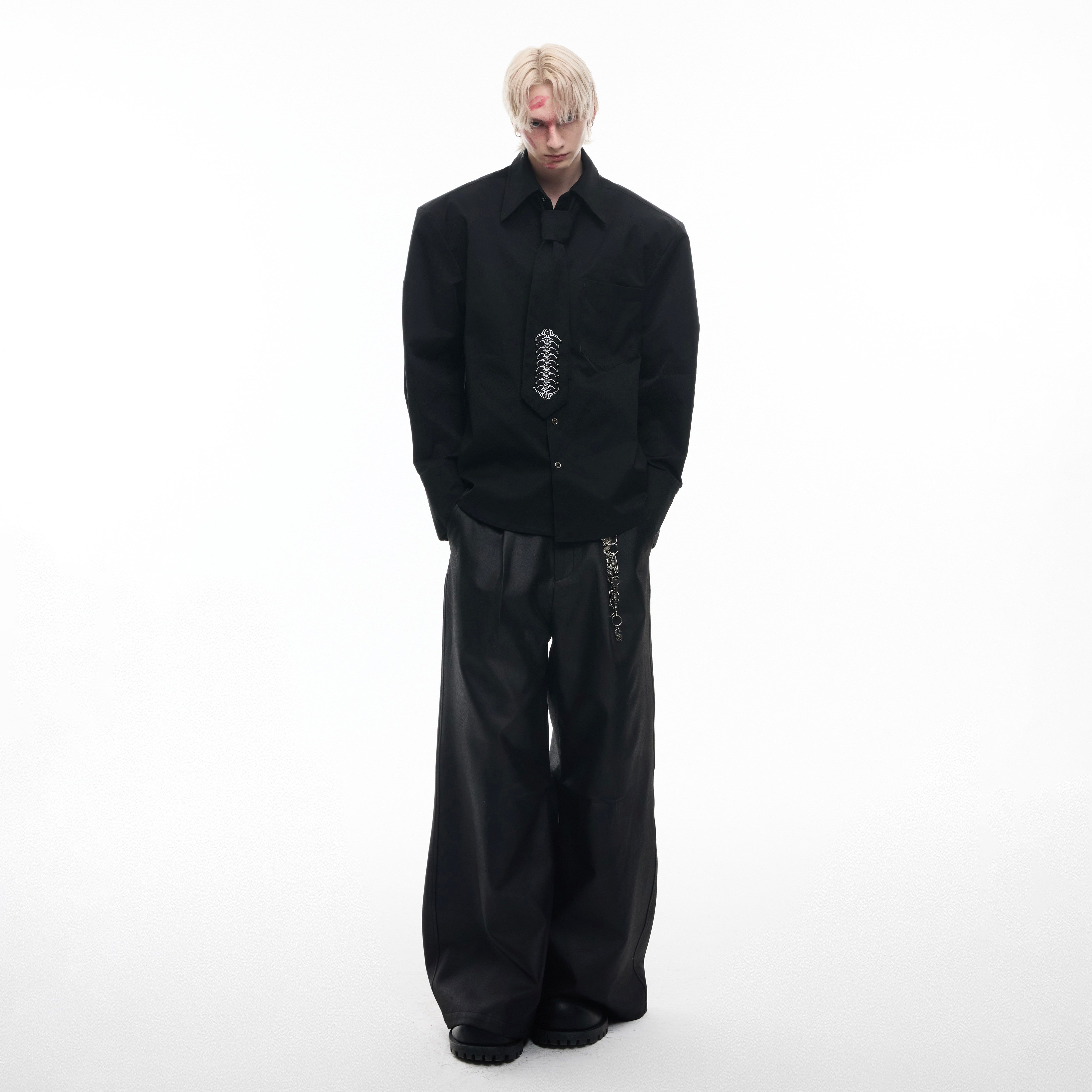 Fashion styling of avant-garde spinal bone shirt with deconstructed details and stand collar