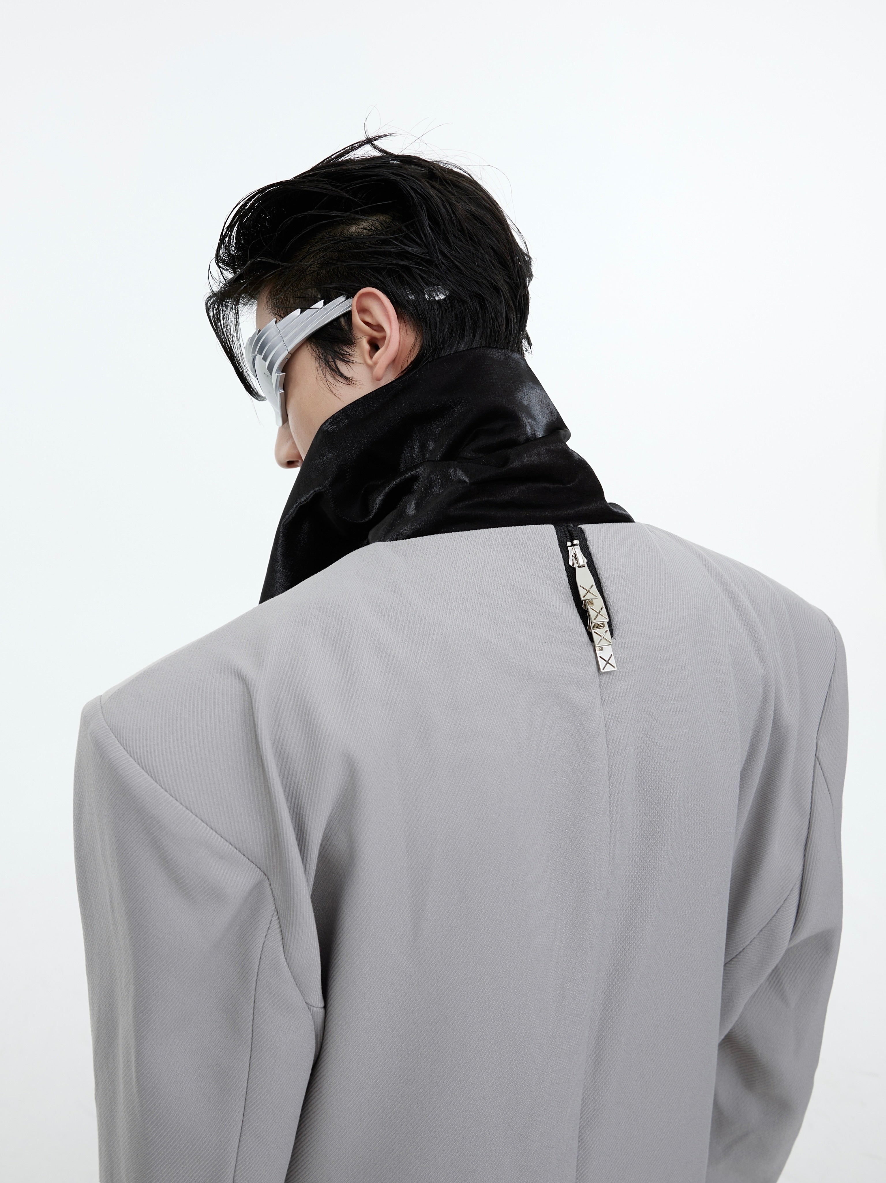 Rear view of deconstructed wool blazer showcasing the distinctive back tie detail and drape