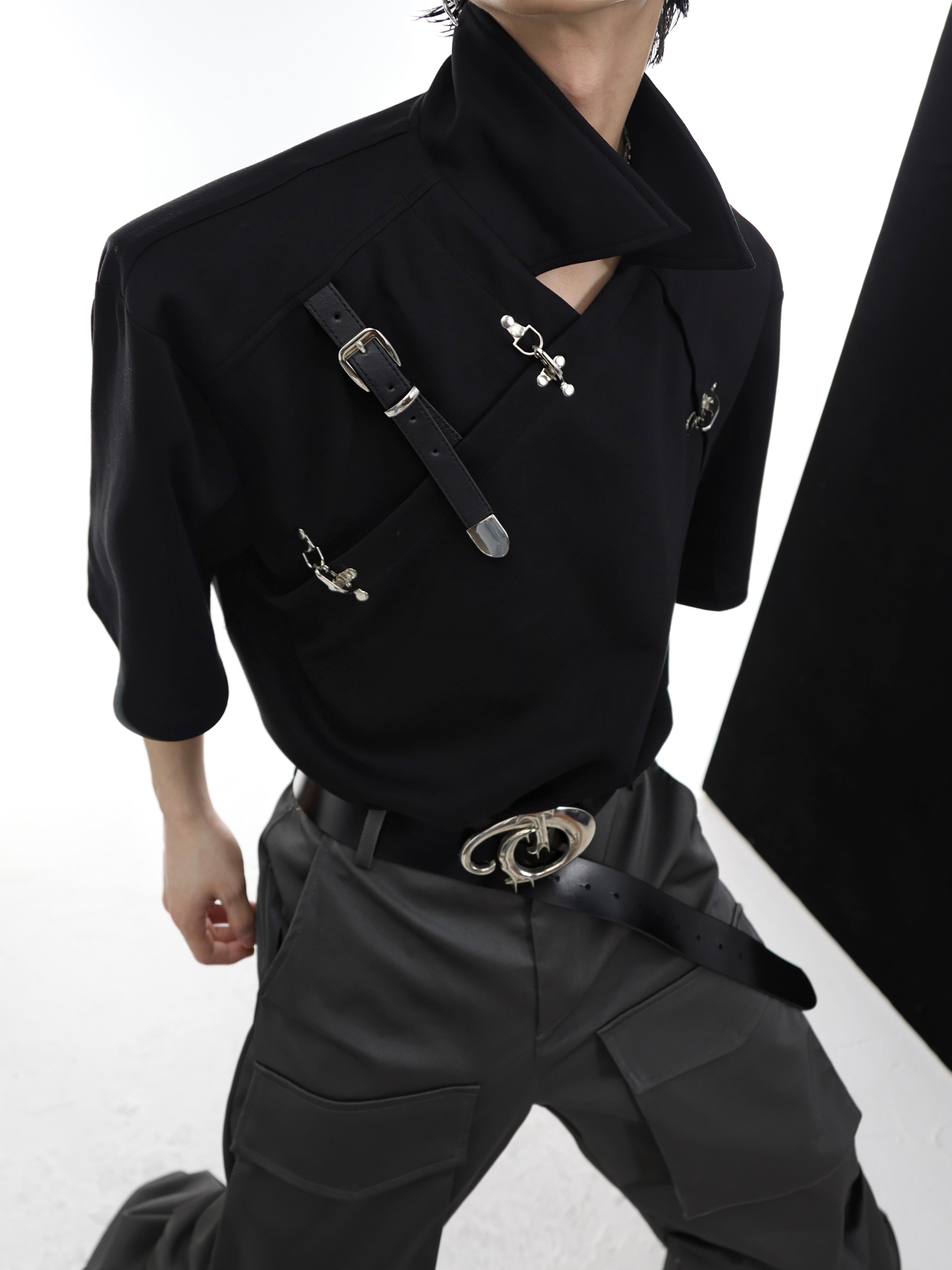 Side view of trendy asymmetric collar polo shirt with distinctive buckle detail
