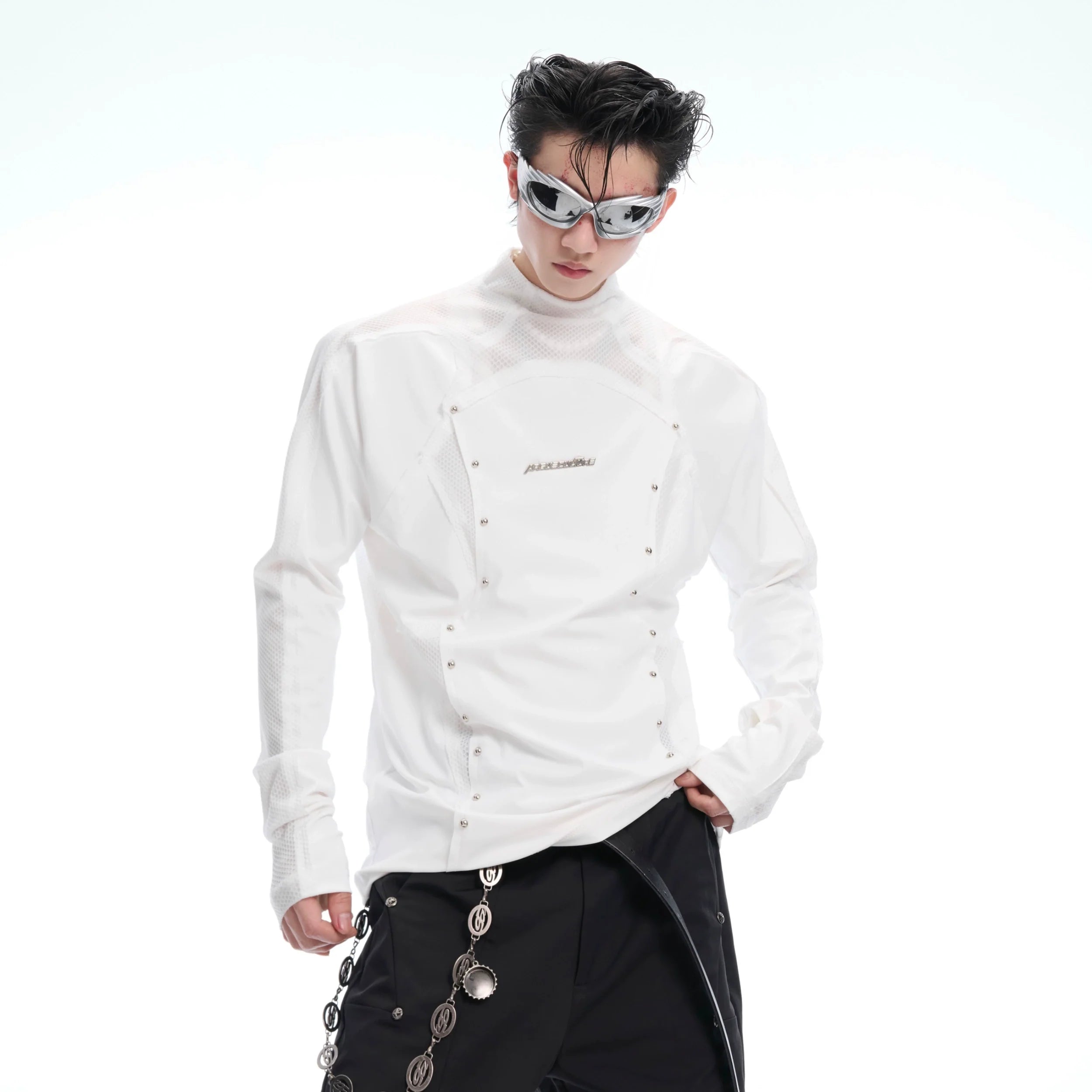 Deconstructed mesh high-neck tee with stud embellishments, showcasing the front design of this edgy streetwear top